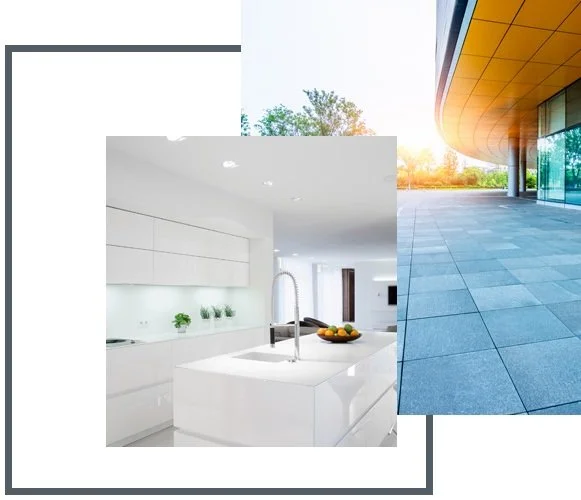 A modern, white kitchen with an island, sink, and minimal decor, adjacent to an outdoor area with a yellow ceiling and stone flooring.