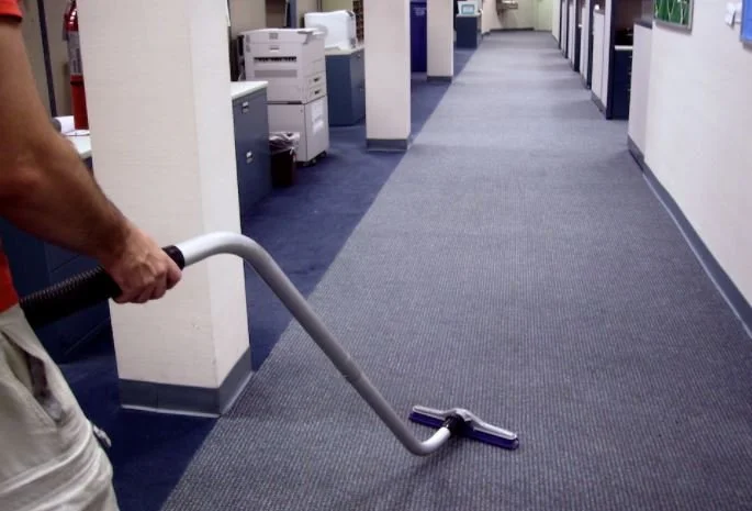KPG cleaning care Professional commercial in Broward County, Boca Raton, Delray Beach, Boynton Beach,Person vacuuming office hallway with a carpet cleaner