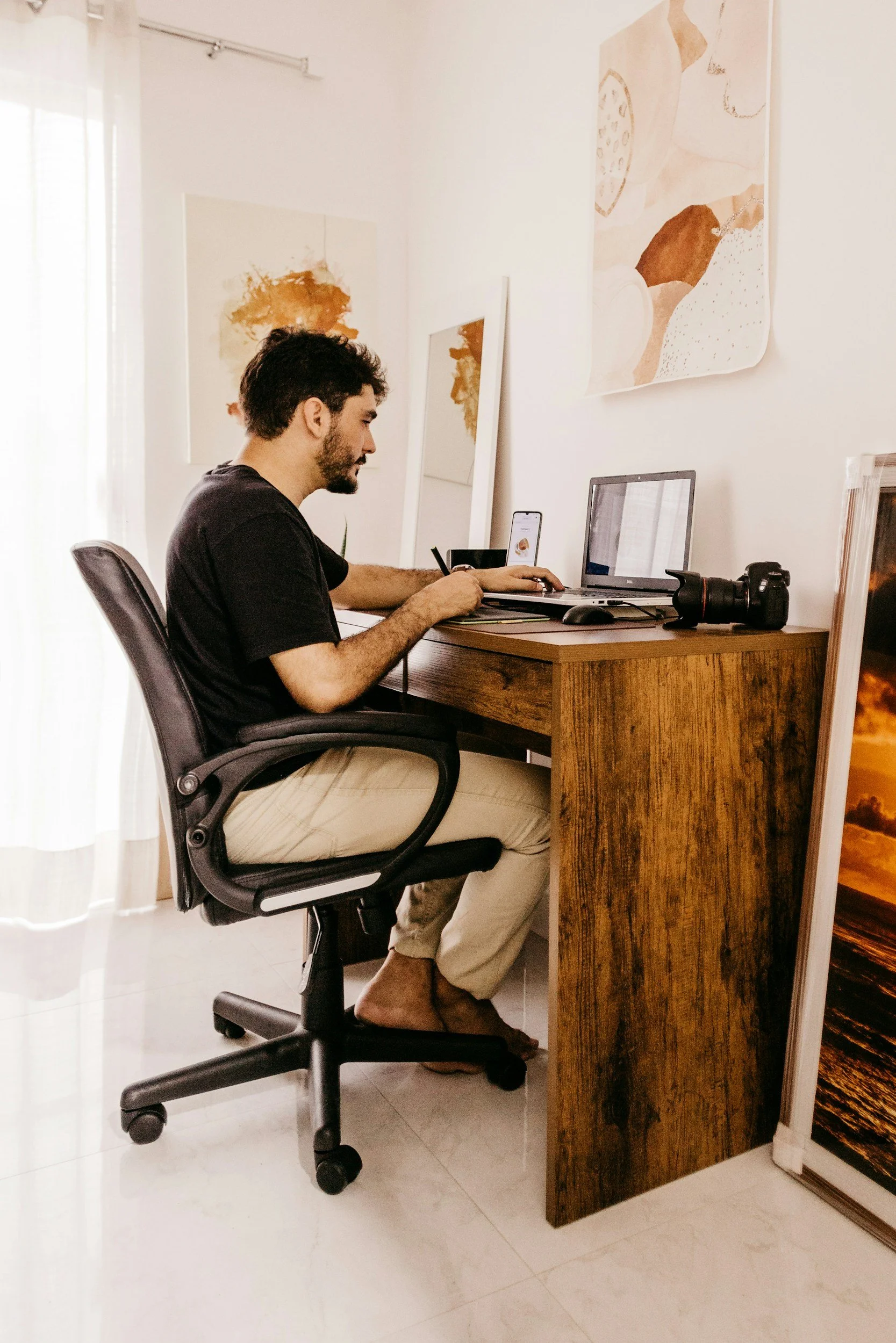man sitting at desk posture contributing to low back and hip pain from prolonged sitting