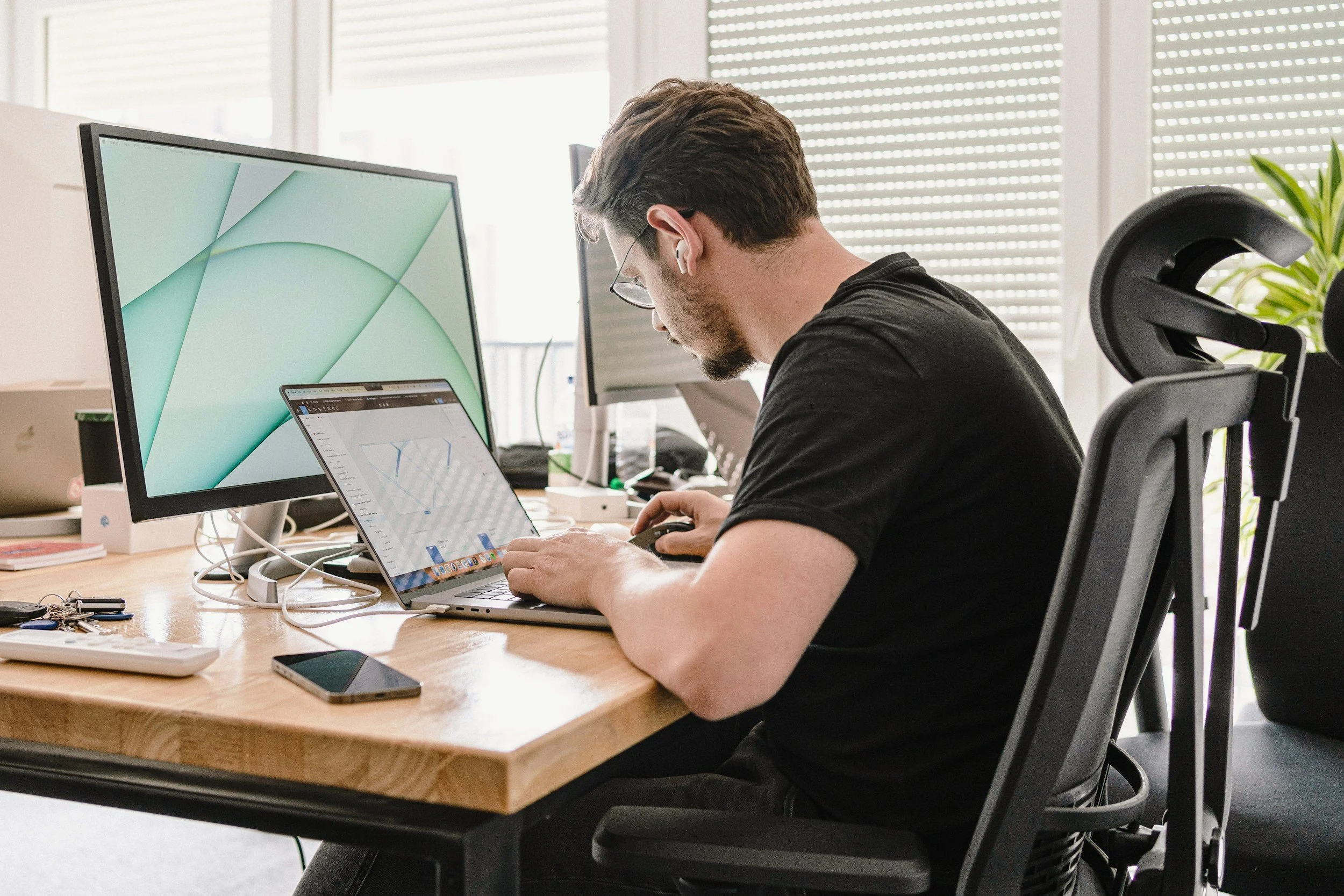 man leaning to one side at desk creating postural imbalance and uneven low back tension