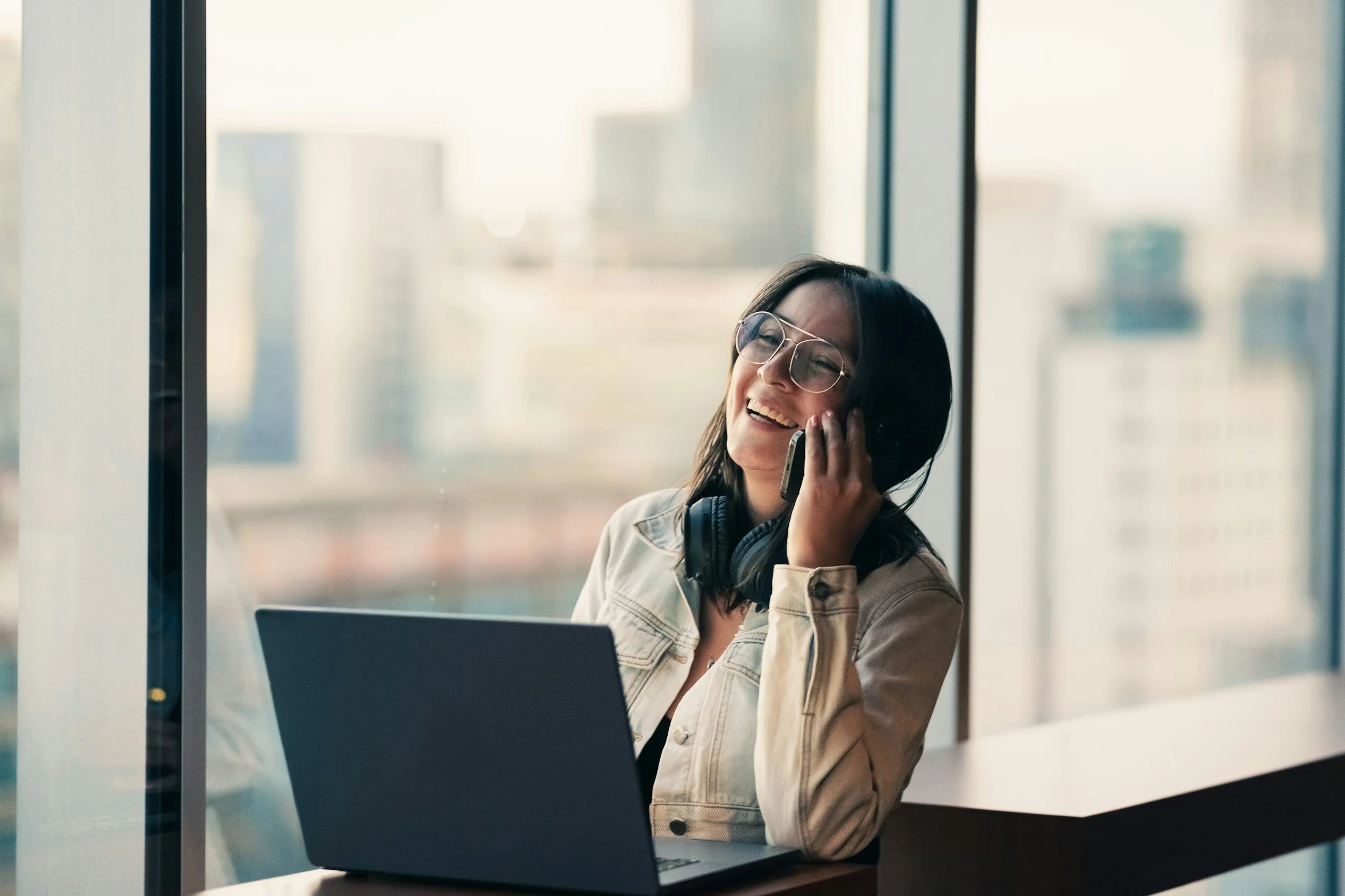 woman working on laptop sitting for long hours causing muscle fatigue and postural strain