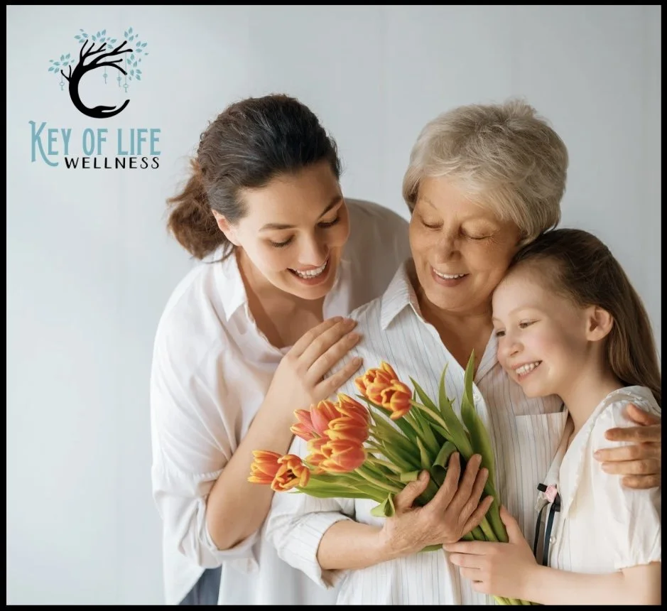 Mother receiving flowers from family as a thoughtful Mother's Day gift idea in Charlotte NC including massage gift certificates at Key of Life Wellness and Massage