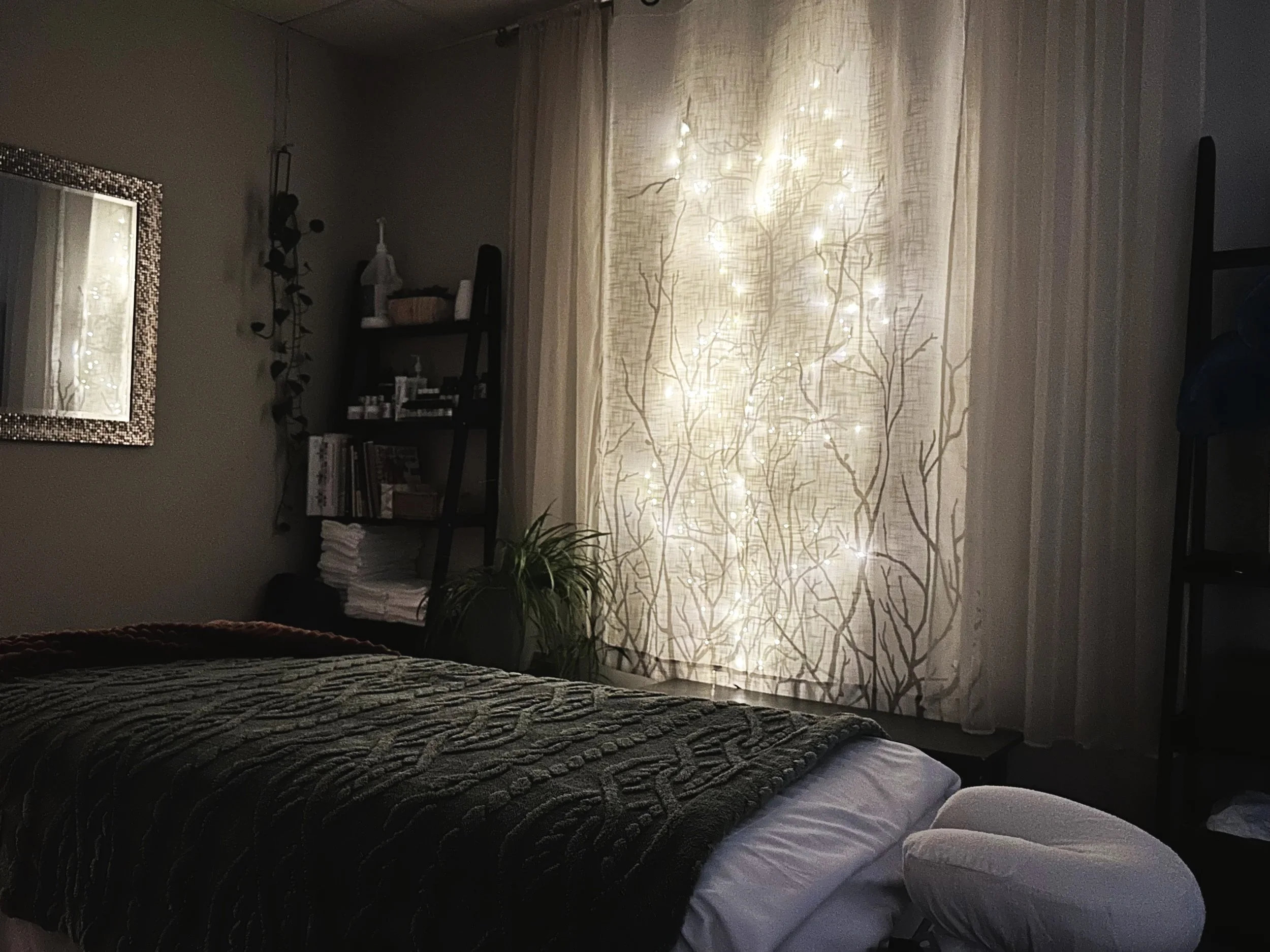 Professional massage therapy treatment room with prepared table and comfortable setting for one-on-one therapeutic bodywork in Charlotte