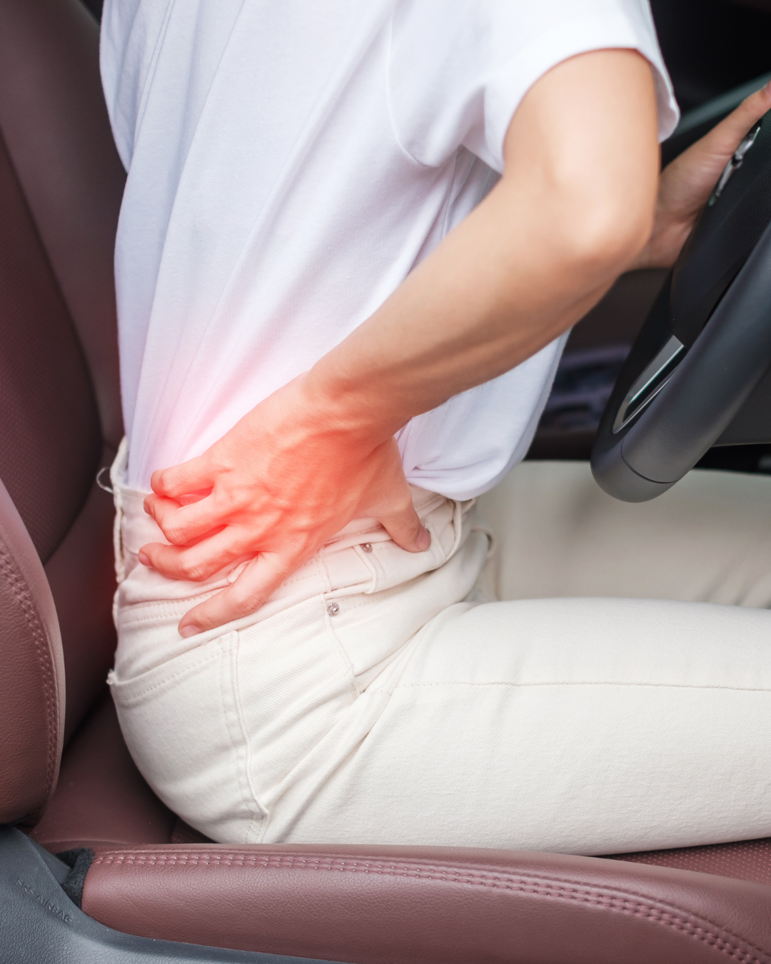 Person experiencing hip and low back stiffness getting out of a car after prolonged sitting