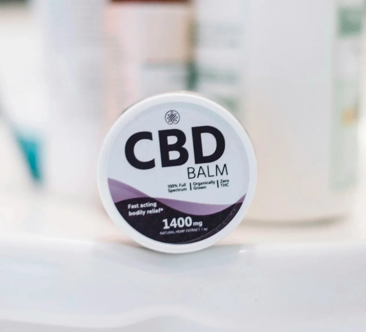Container of CBD topical cream used for muscle recovery and pain relief.