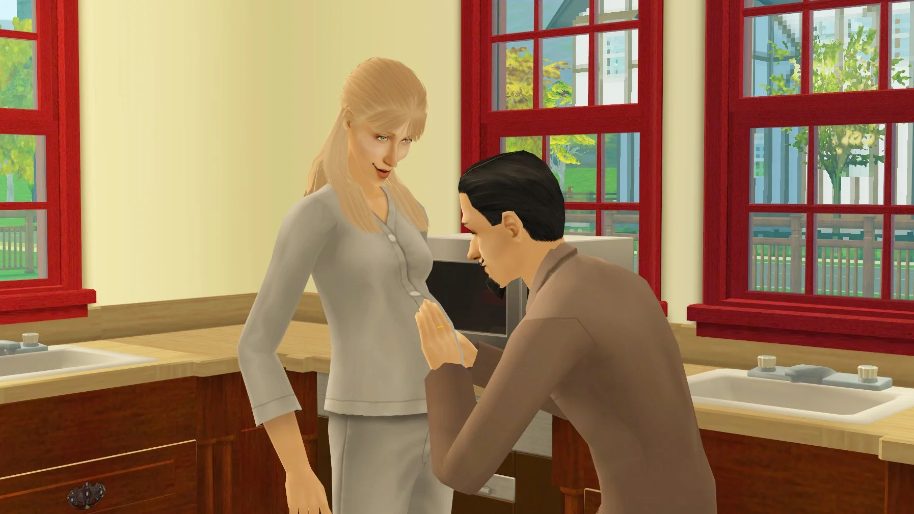 Cornwall Capp feeling the tummy of his pregnant wife Regan Capp