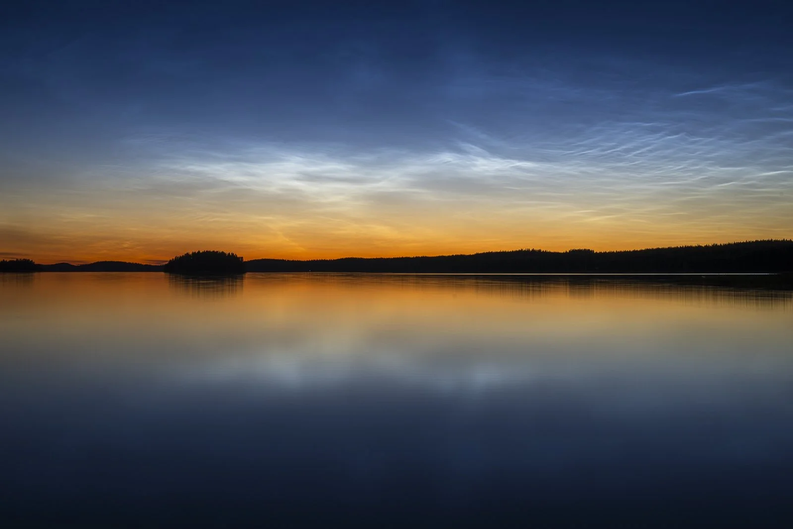 Silent Saimaa landscape beneath noctilucent clouds during the Nordic summer night