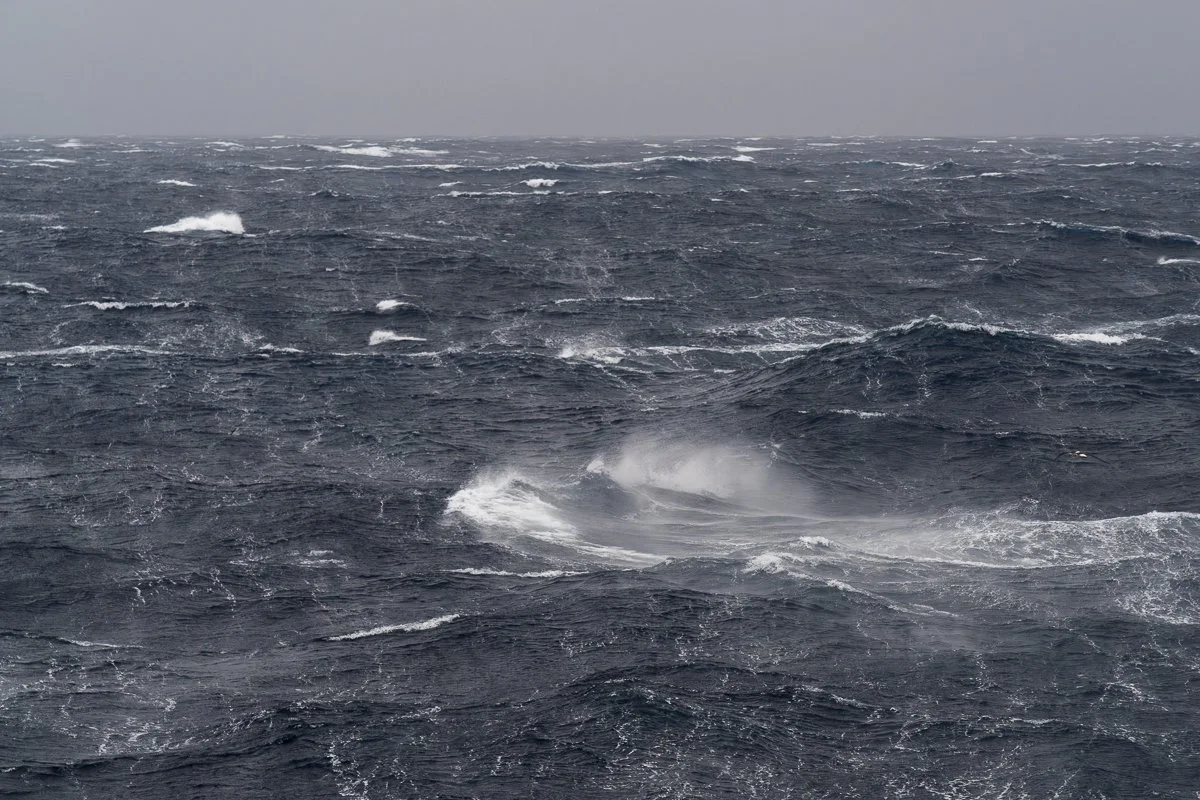 The Drake Passage in strong wind, with rough sea and a grey horizon.