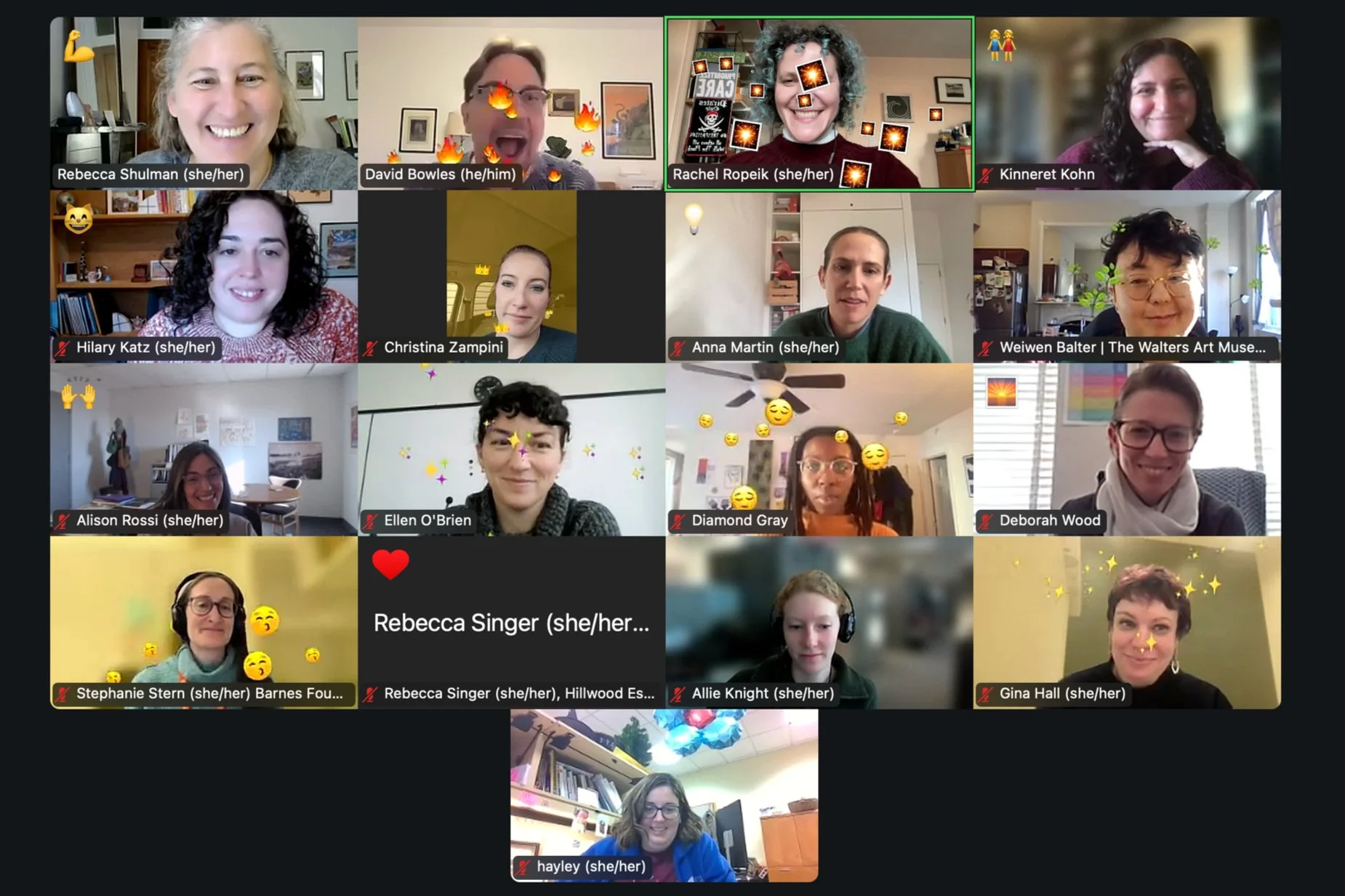 A grid of 17 Zoom boxes on screen, each one with a person and an emoji reaction showing with smiling faces.