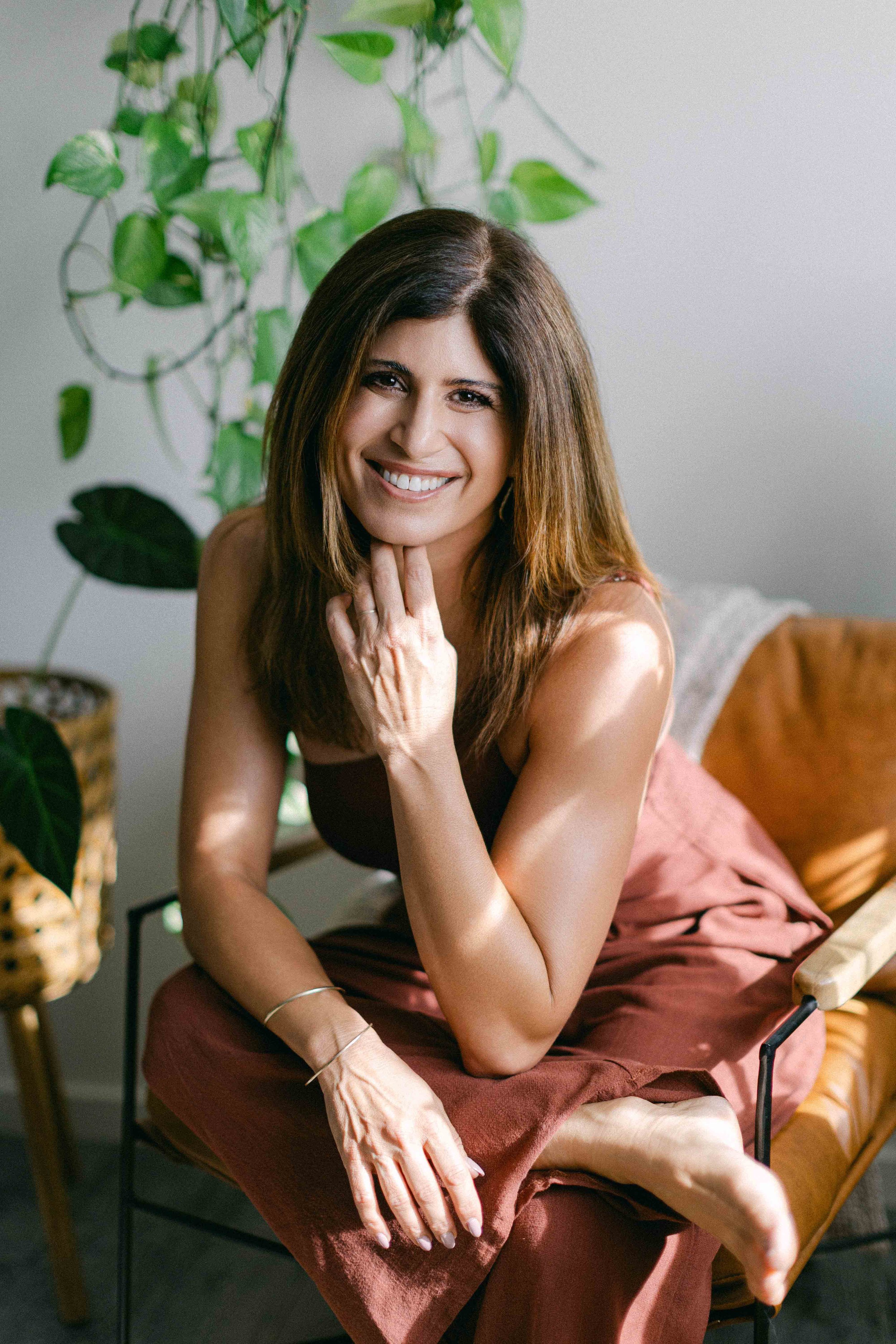Jennifer sitting in chair in her healing studio.