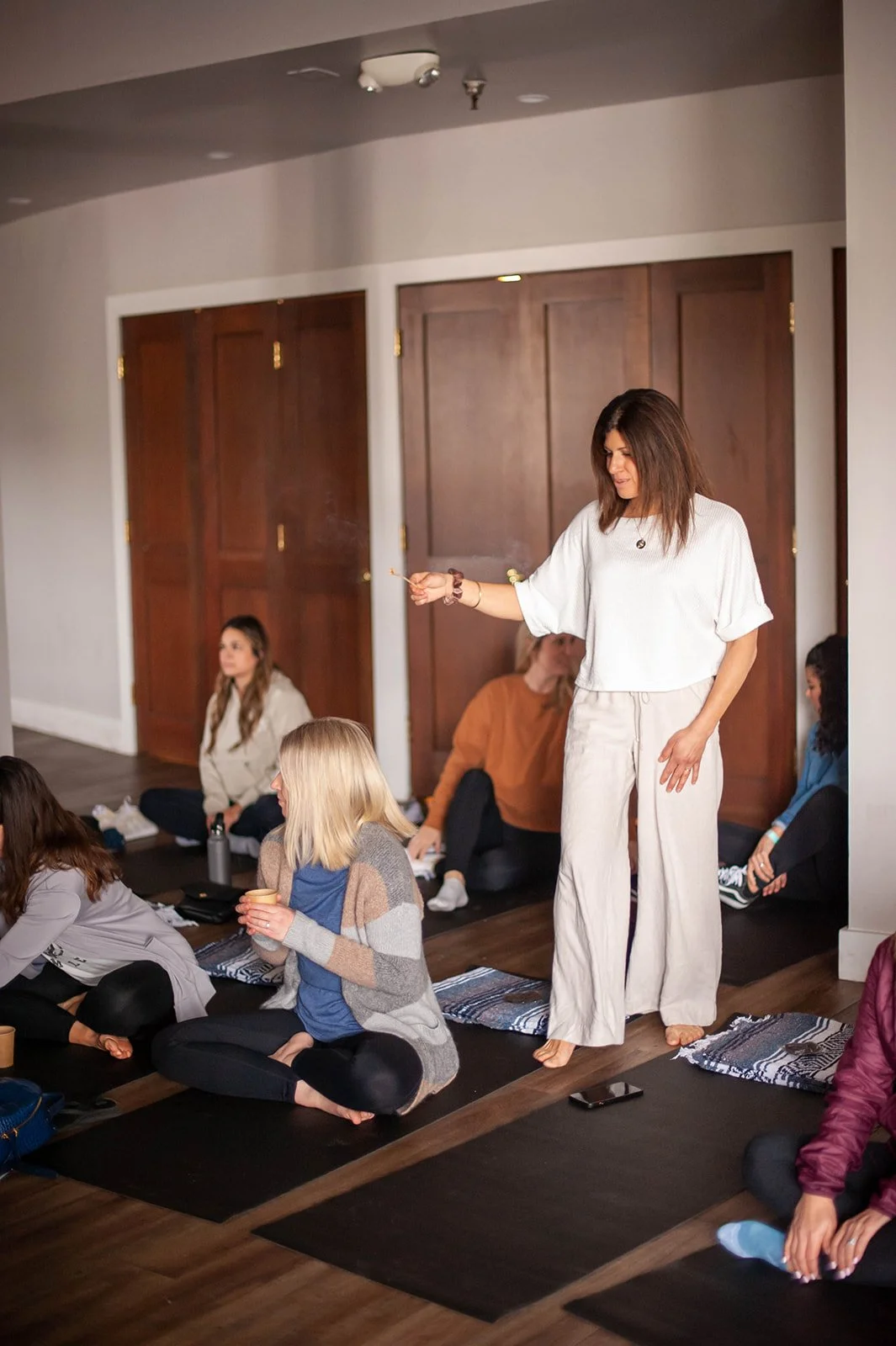 Jennifer leading a women’s breathwork ceremony, guiding a small group seated on yoga mats