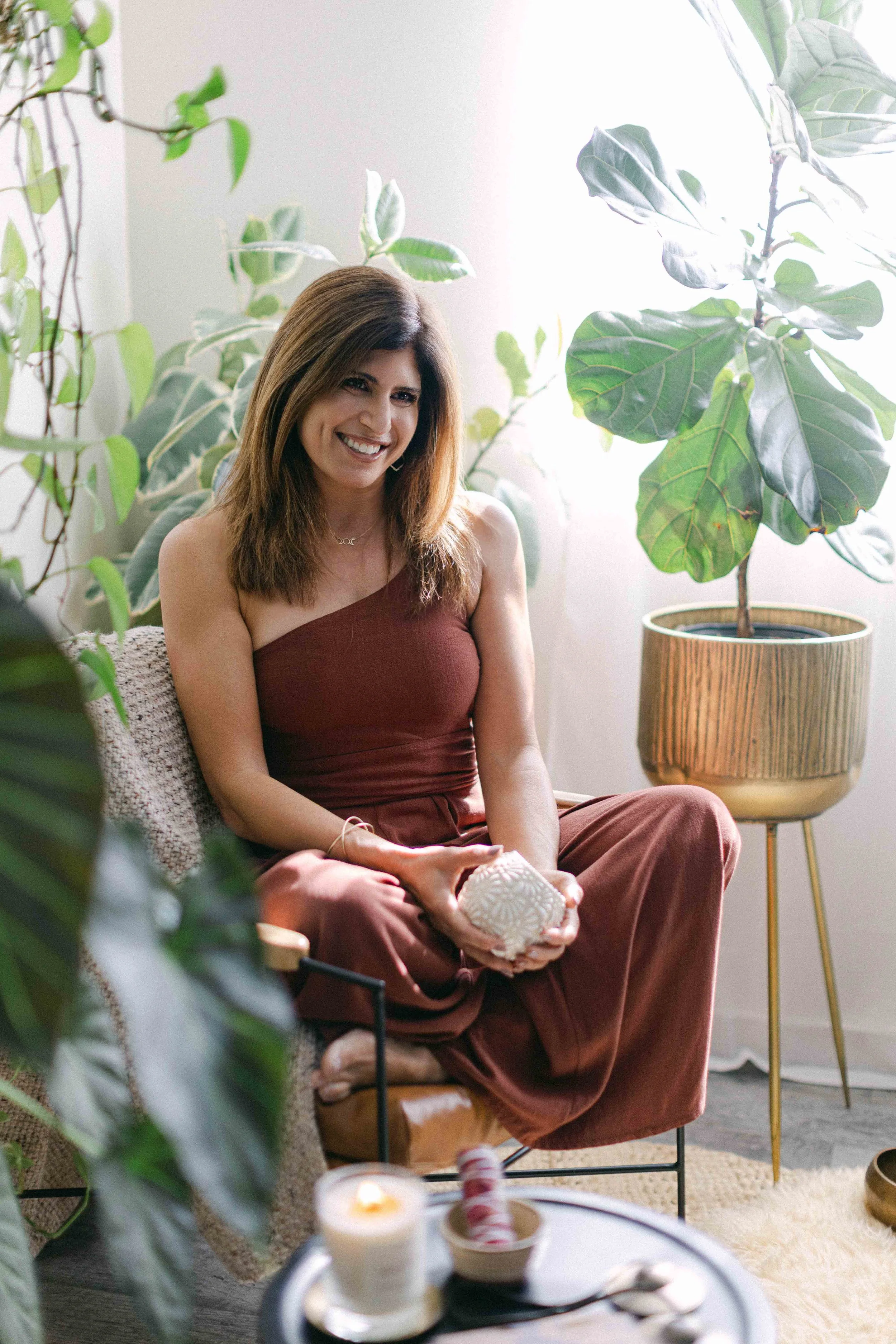 Jennifer smiling in a calm wellness space in Orange County, California.