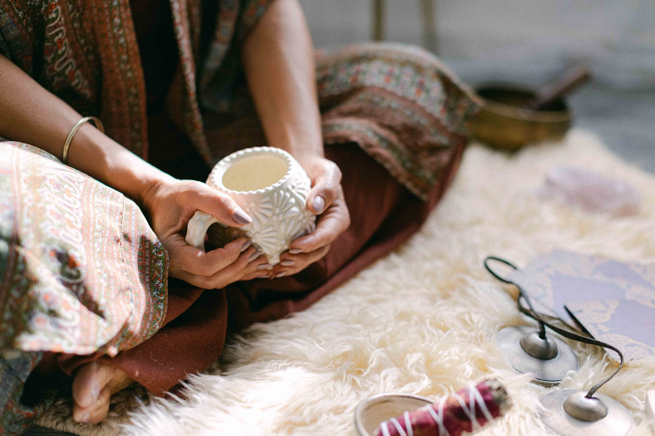 Woman holding a cup during a Highest Source Healing experience