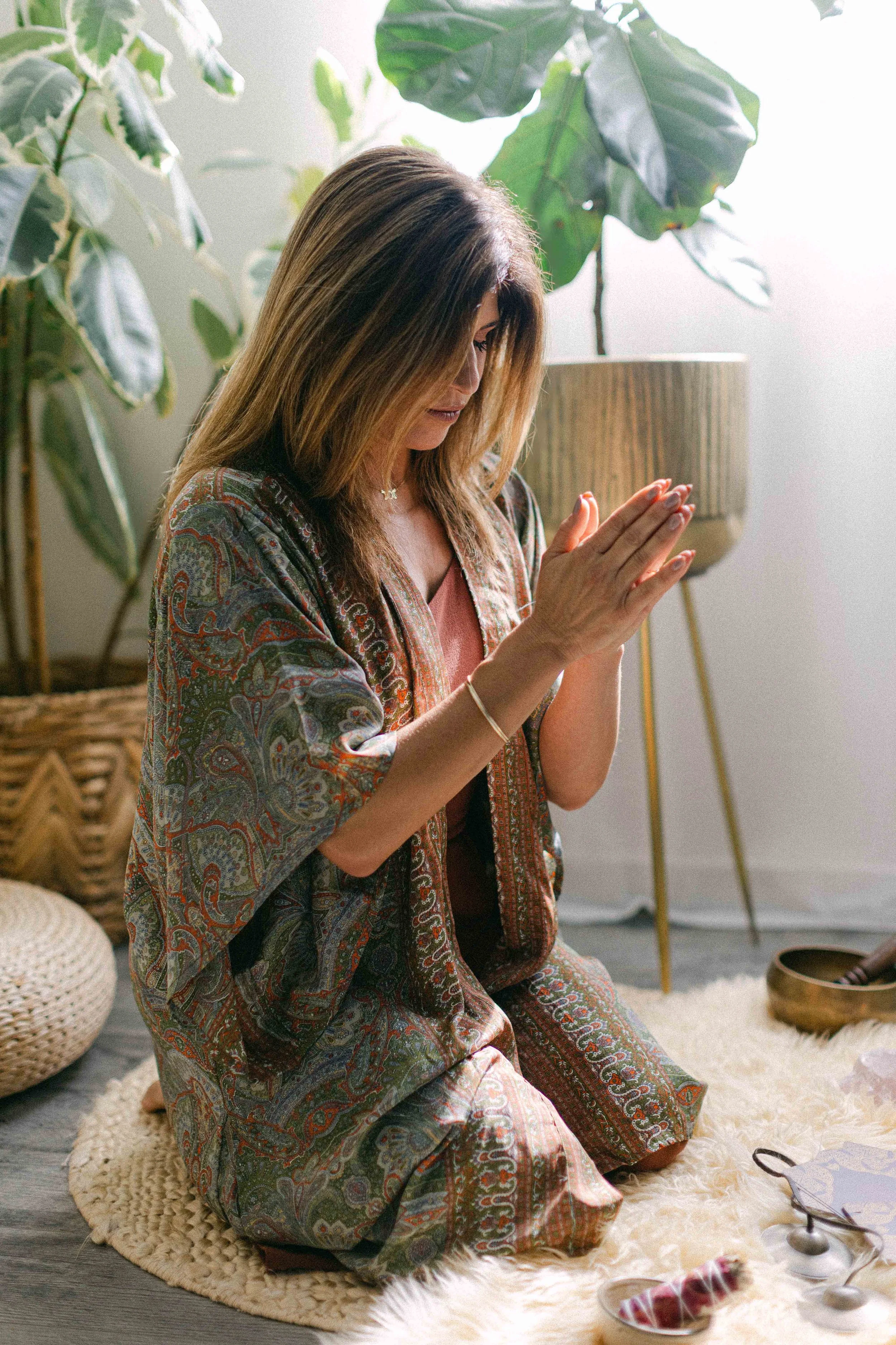 Jennifer holding her hands in prayer position before giving reiki healing.