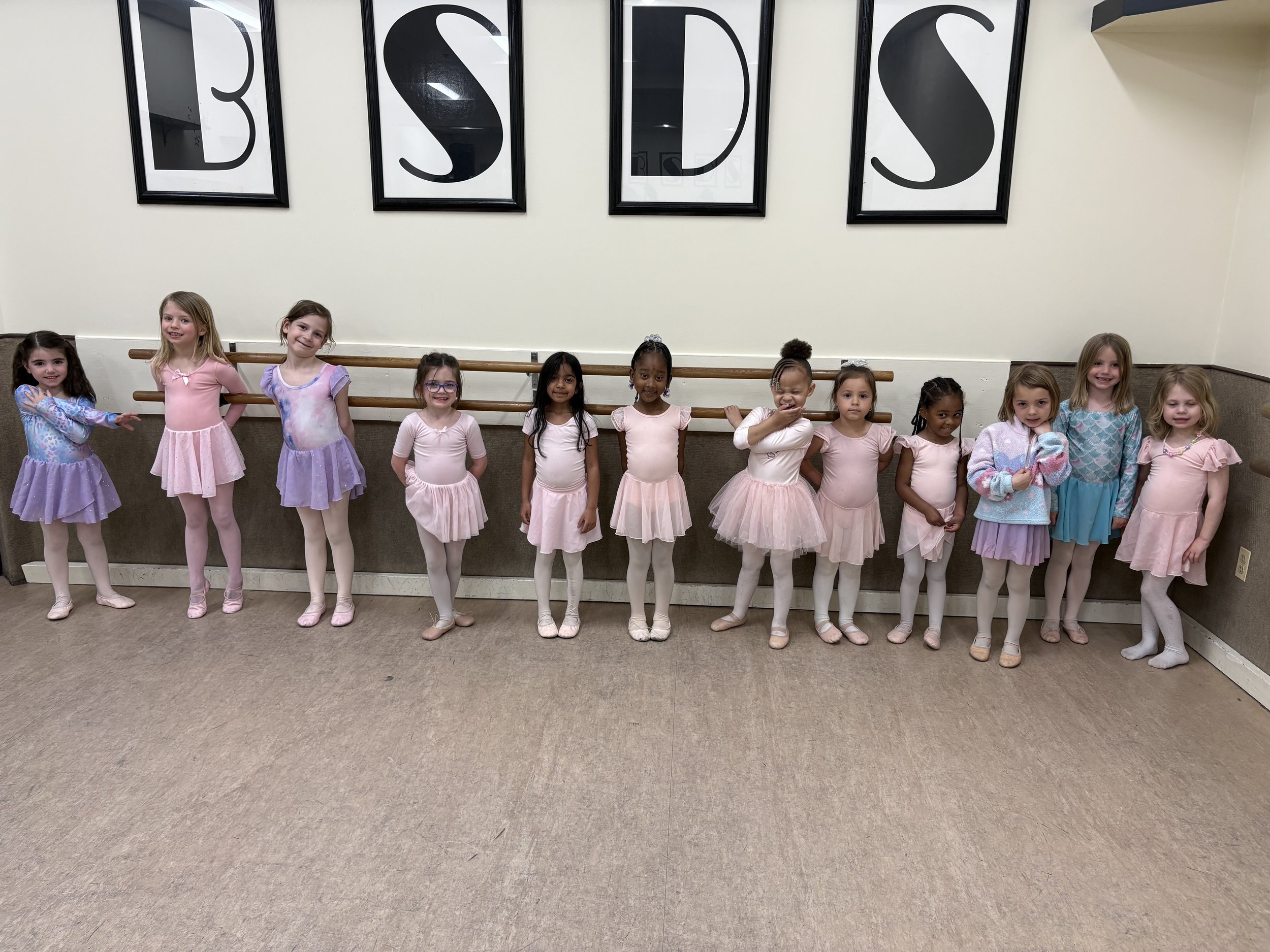 Young dancers smiling and having fun during dance class at Backstage Dance Studio in Columbia, MD.