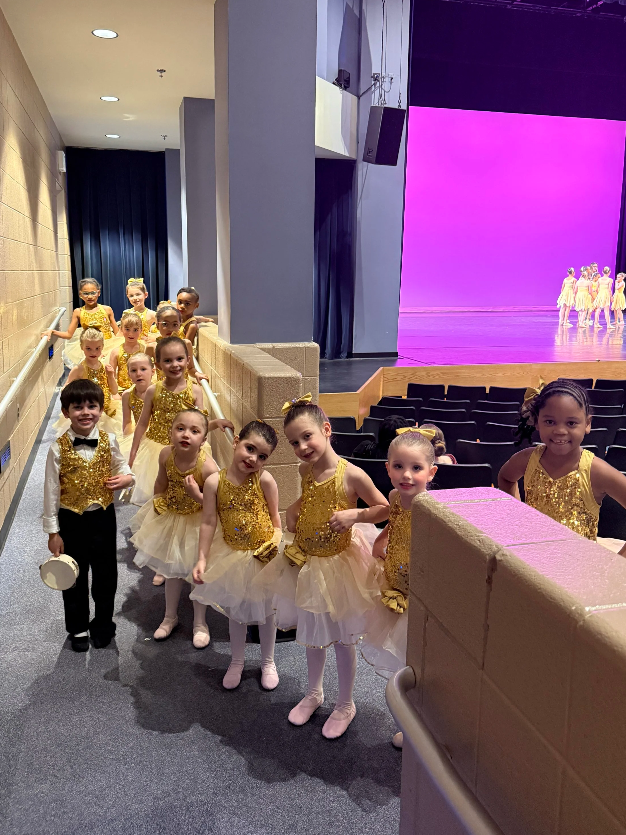 Backstage Dance Studio dancers standing in the audience during dress rehearsal, ready to take the stage for their next performance.