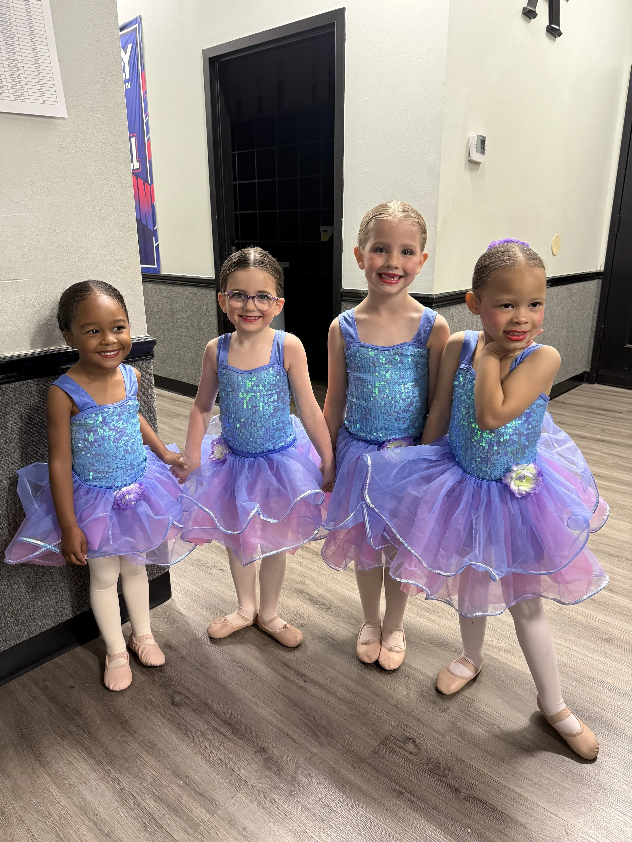 Backstage Dance Studio dancers smiling together in costume and ready for annual dance picture day.
