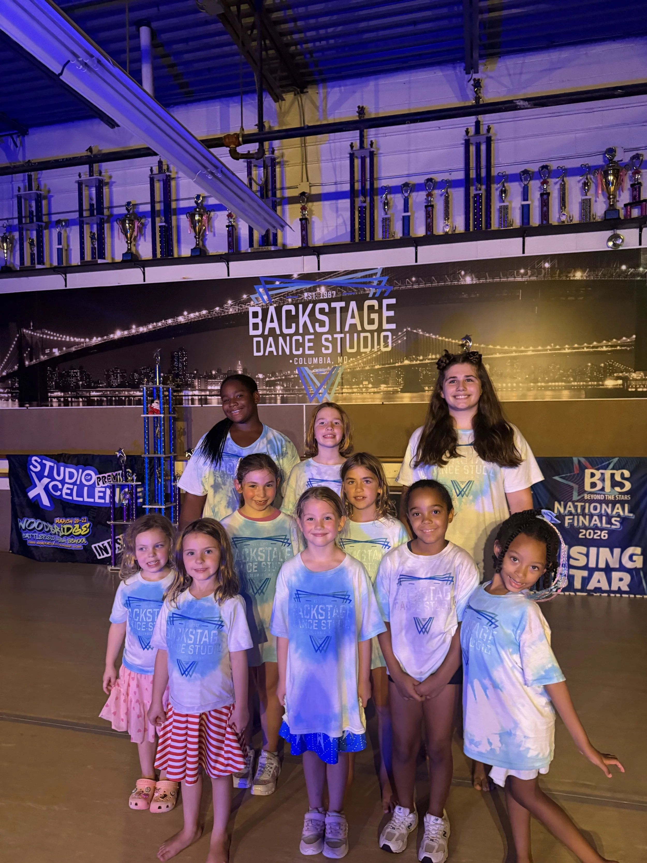 Disney Dance Camp students smiling together for a group photo at Backstage Dance Studio in Columbia, MD.