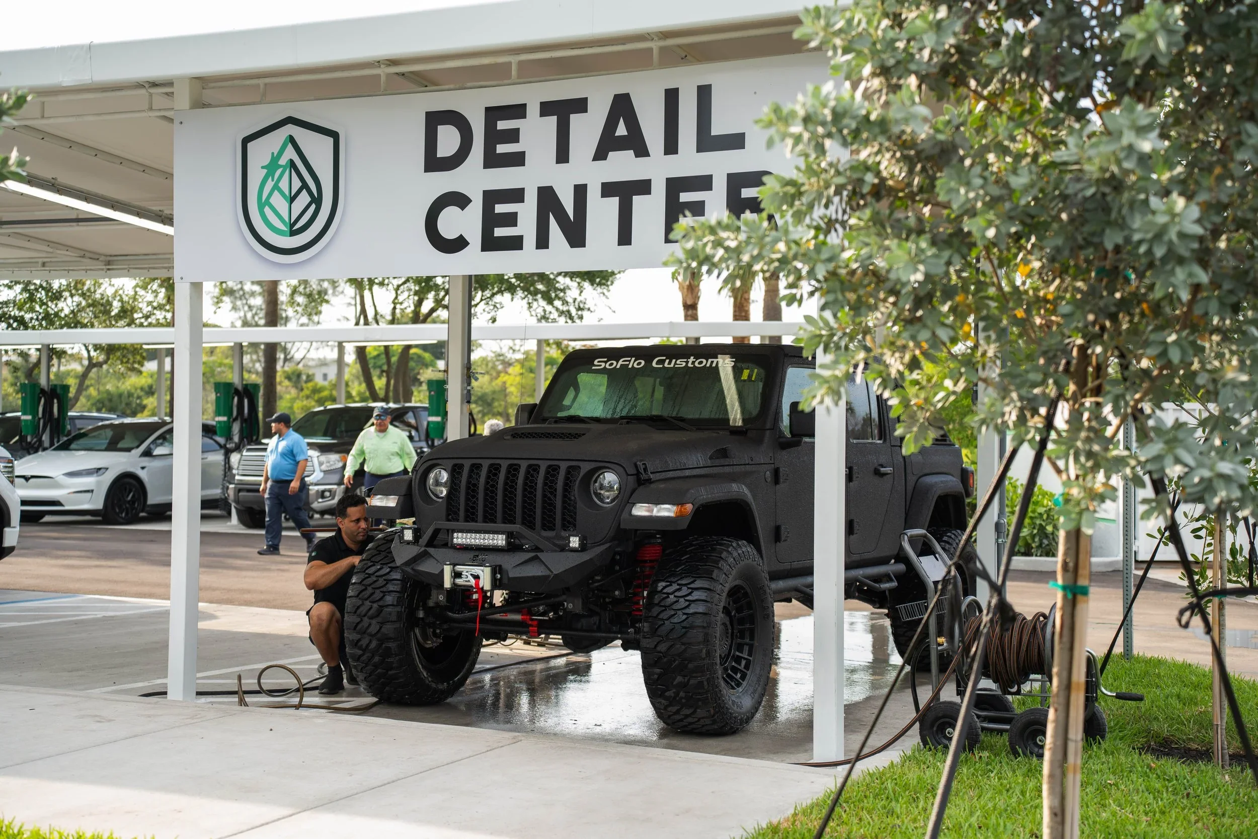 Auto detailing expert at Mint Eco car detail services center working on a custom black jeep.