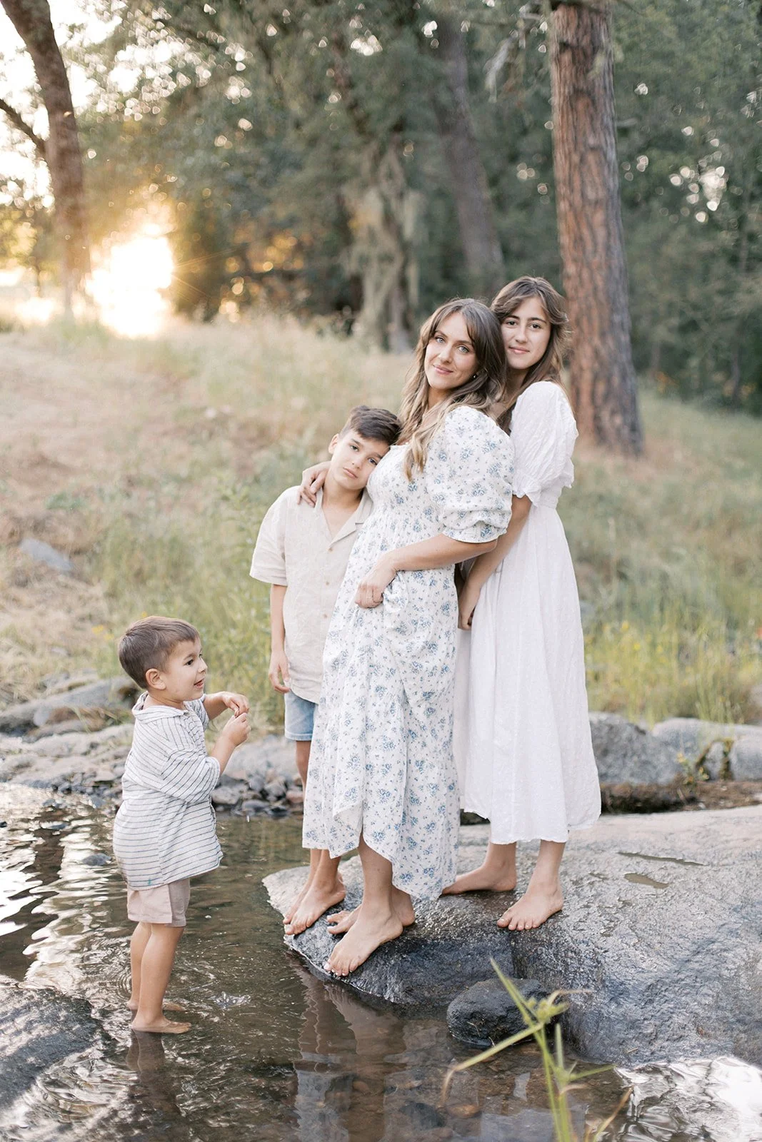 Mother &amp; kids by the creek