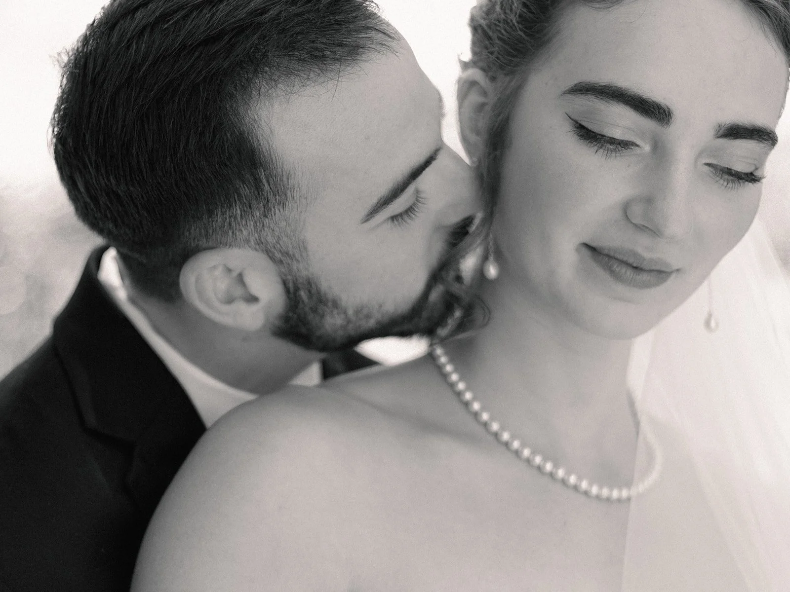 Bride with pearls and groom in black and white
