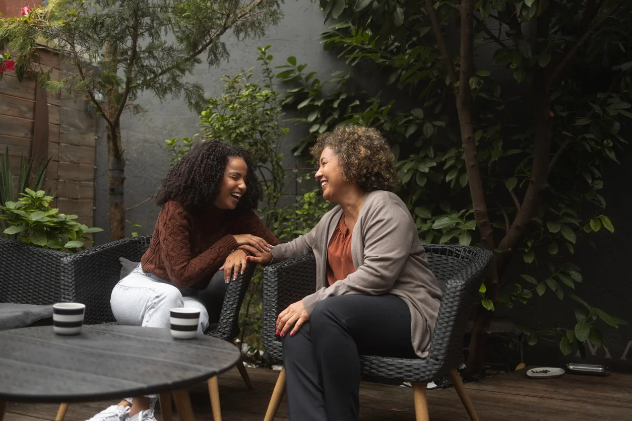 Mother and daughter having a conversation over coffee - setting boundaries with immigrant parents