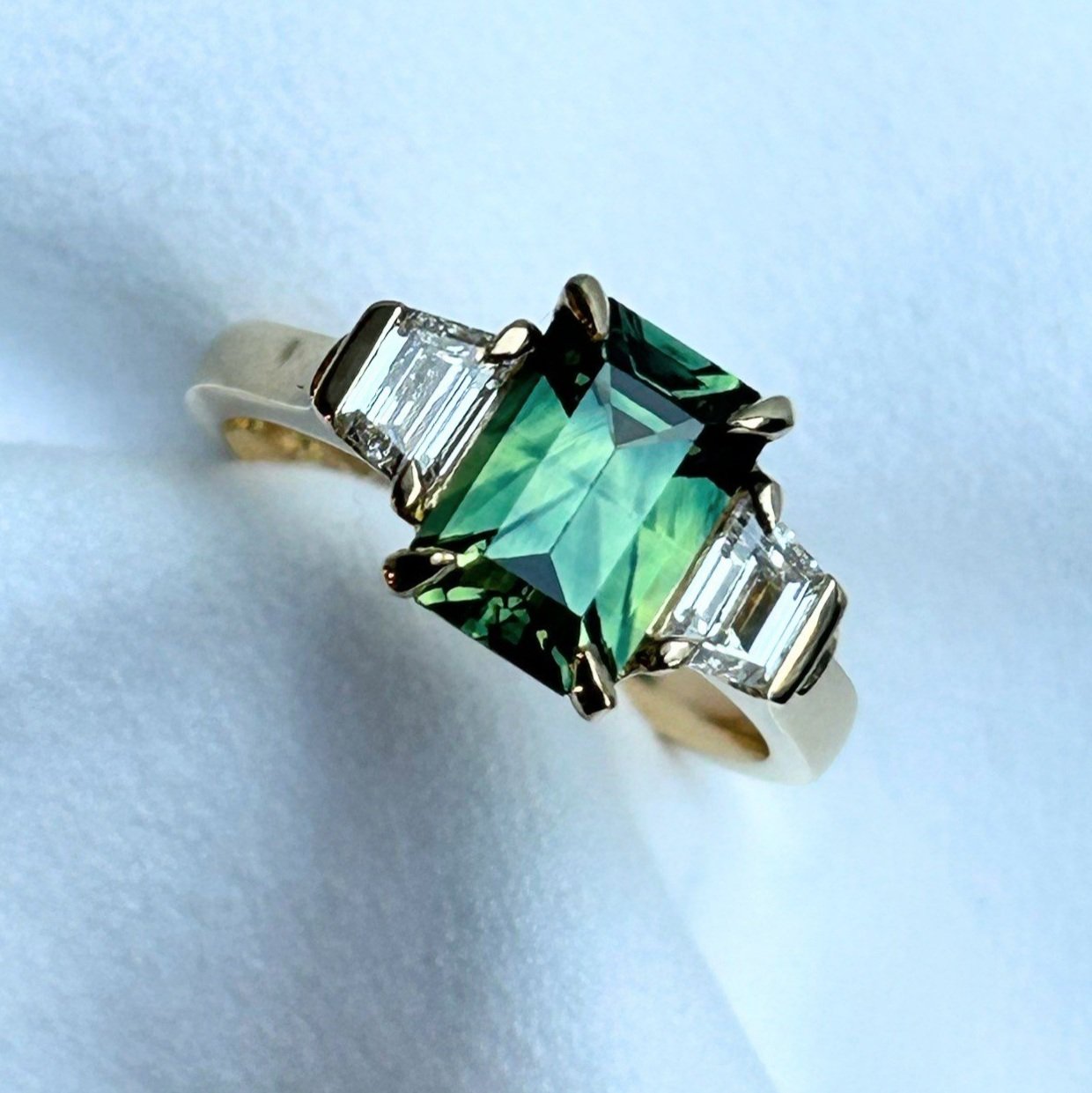 Emerald-cut sapphire and diamond three stone ring