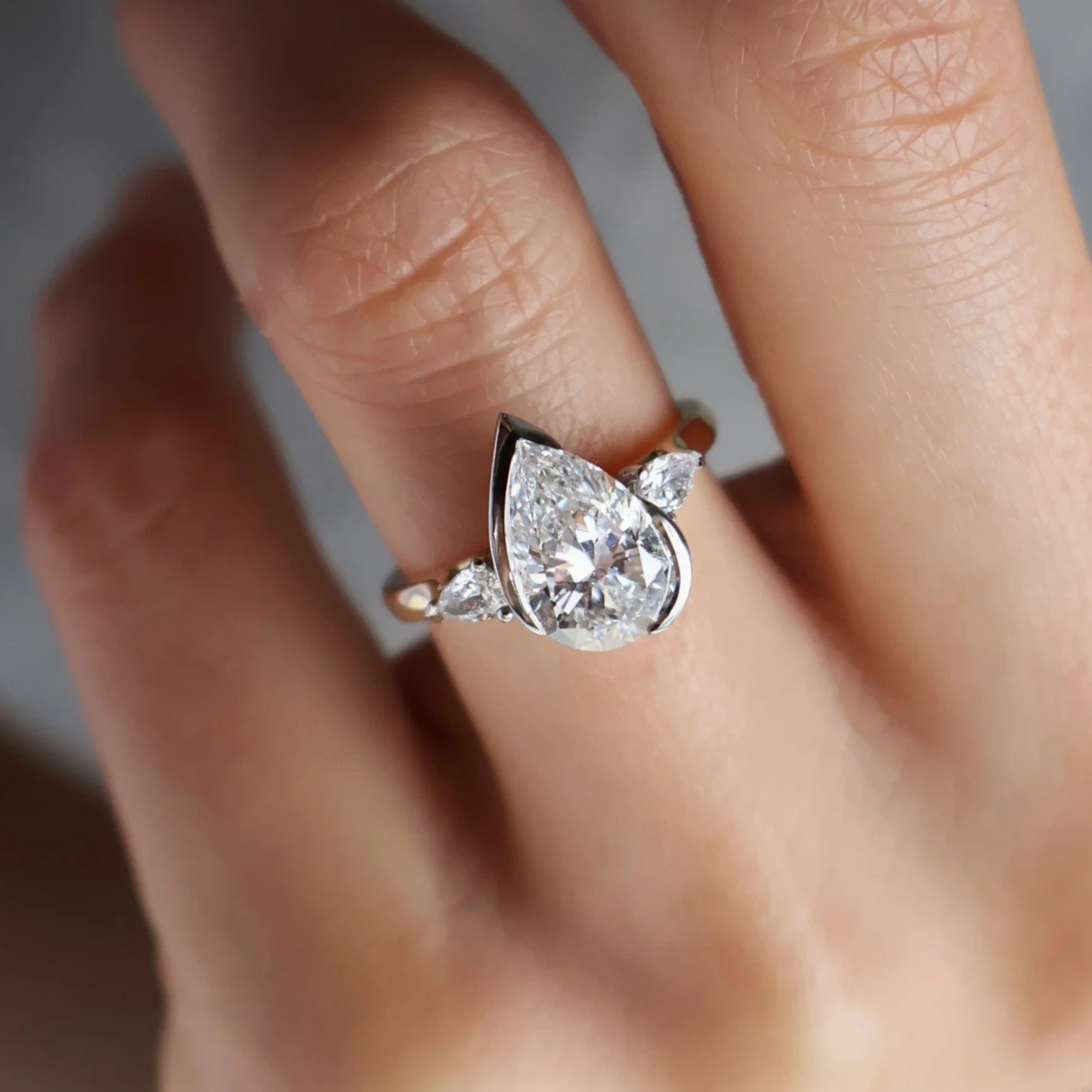 Pear diamond three stone engagement ring