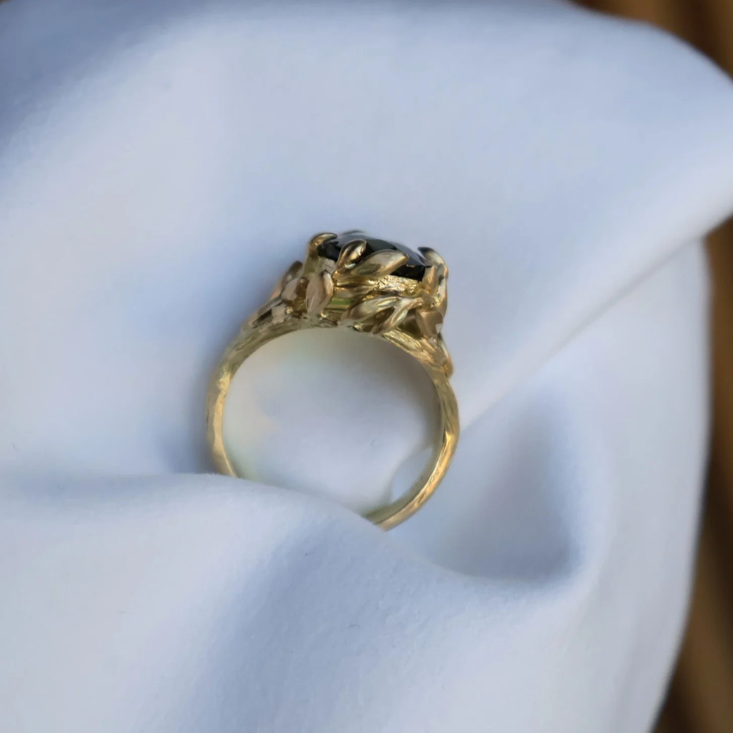 Nature inspired leaf ring with green gemstone 
