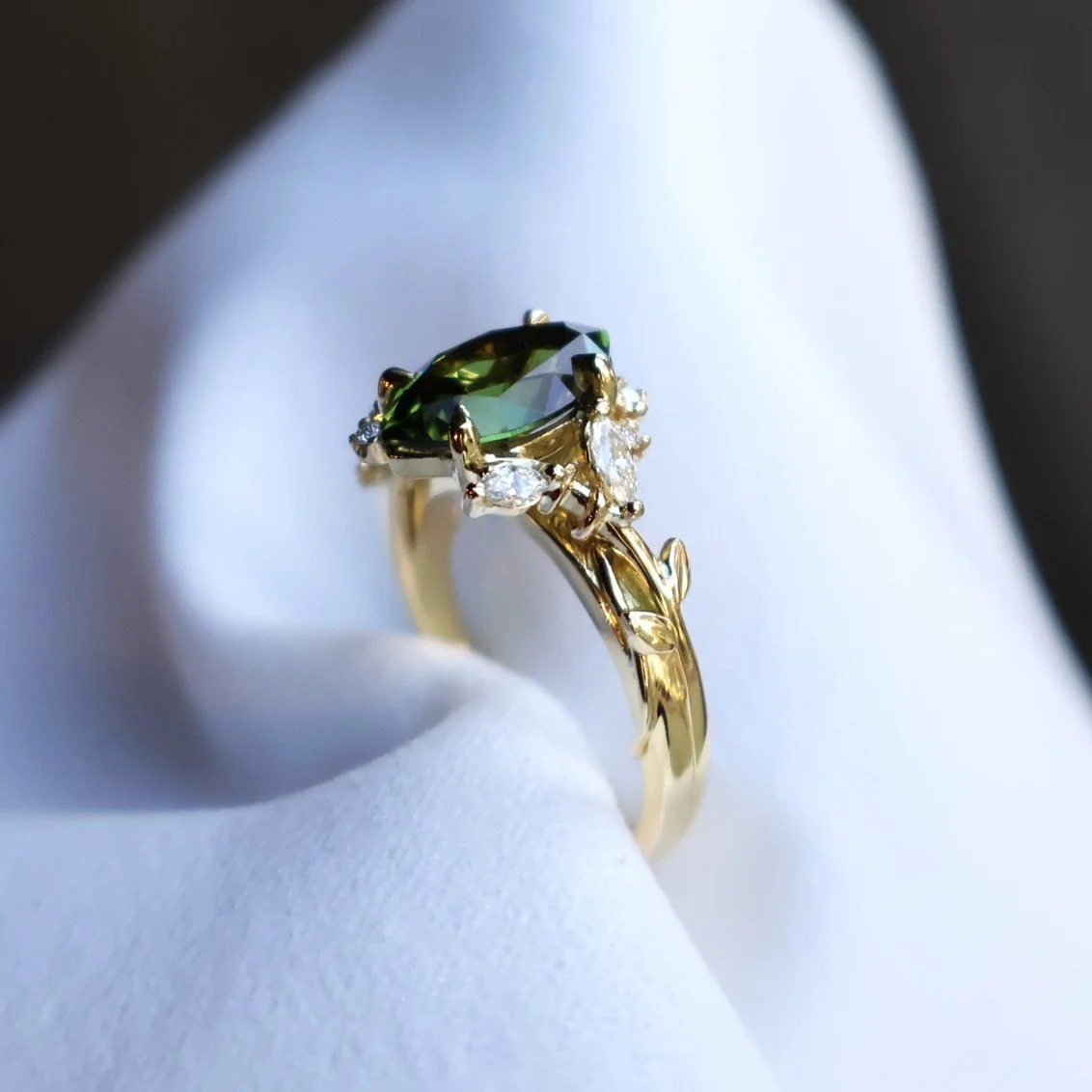 Nature inspired engagement ring with green sapphire