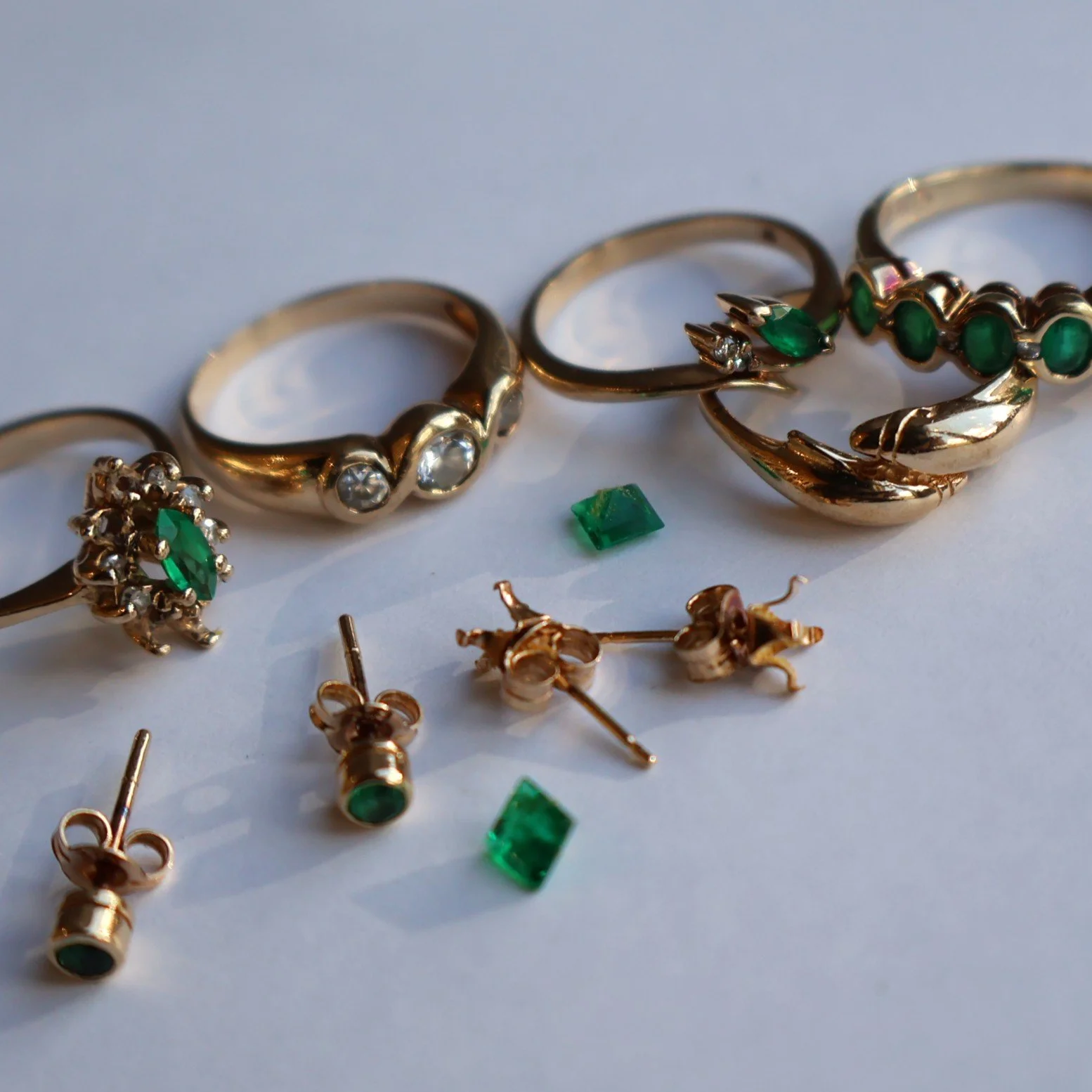 Emerald and diamond set rings and earrings before remodelling