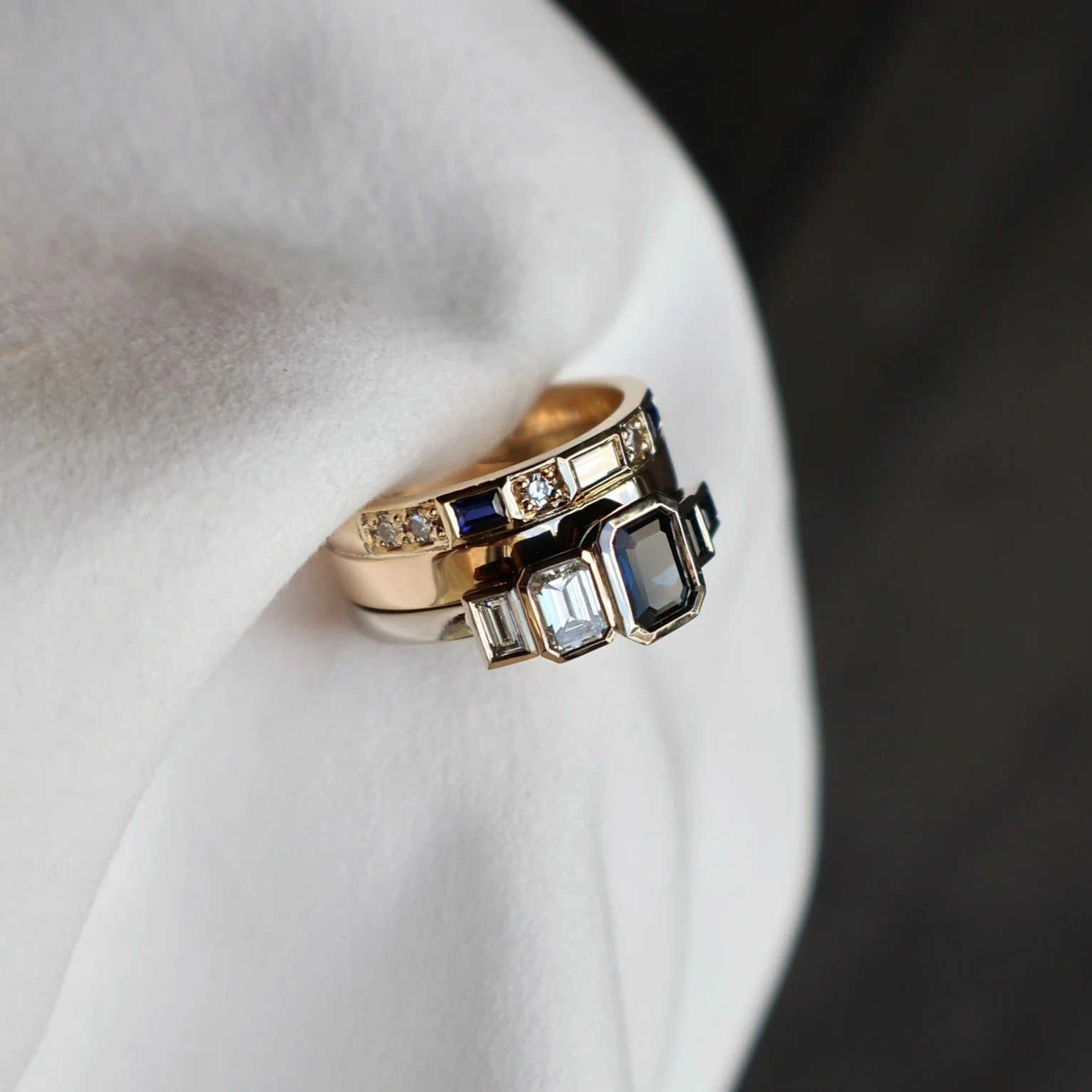 Remodel jewellery after image blue emerald cut sapphire and diamond two tone ring stack side view.JPG