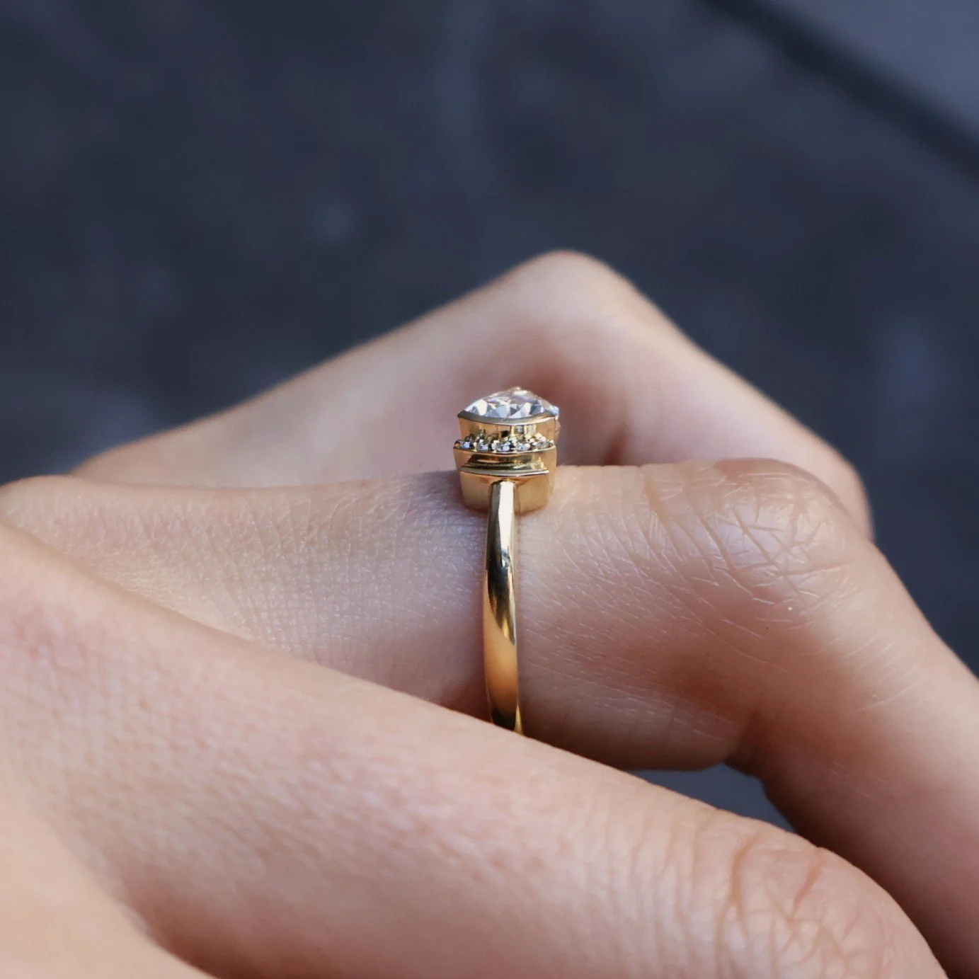 Side view modern art deco ring made in 18ct yellow gold set with a 1.26ct pear lab diamond