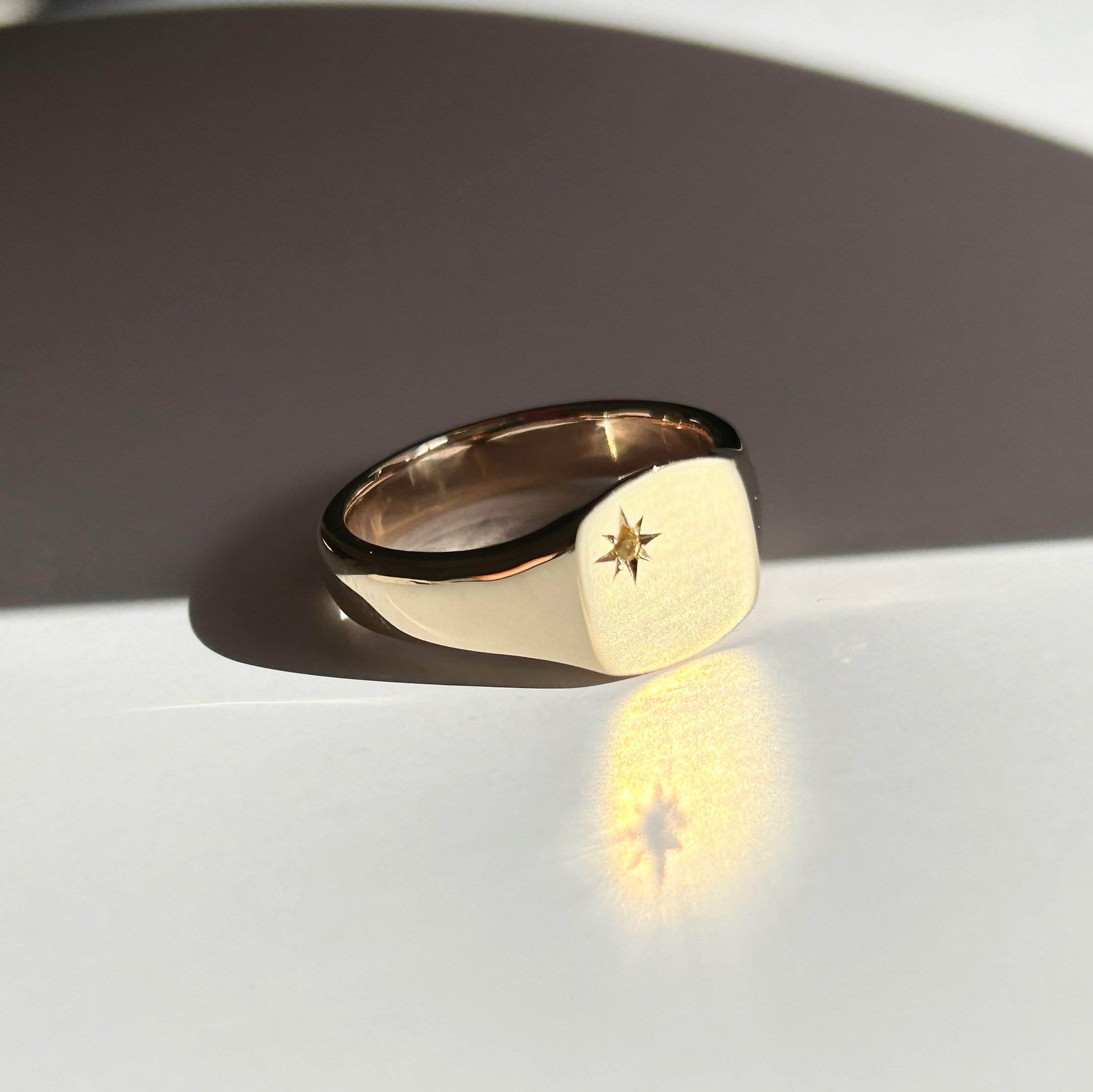 Solid gold signet ring set with a sapphire