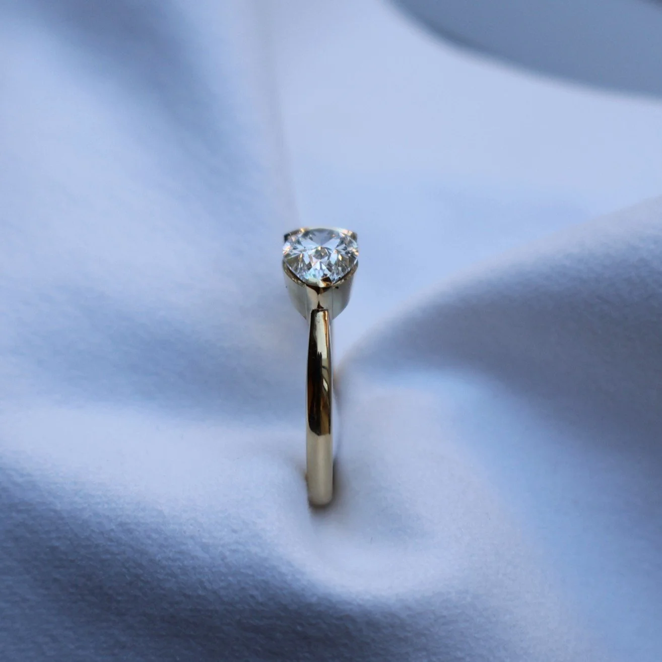 Pear diamond engagement ring made in a modern art deco style side view