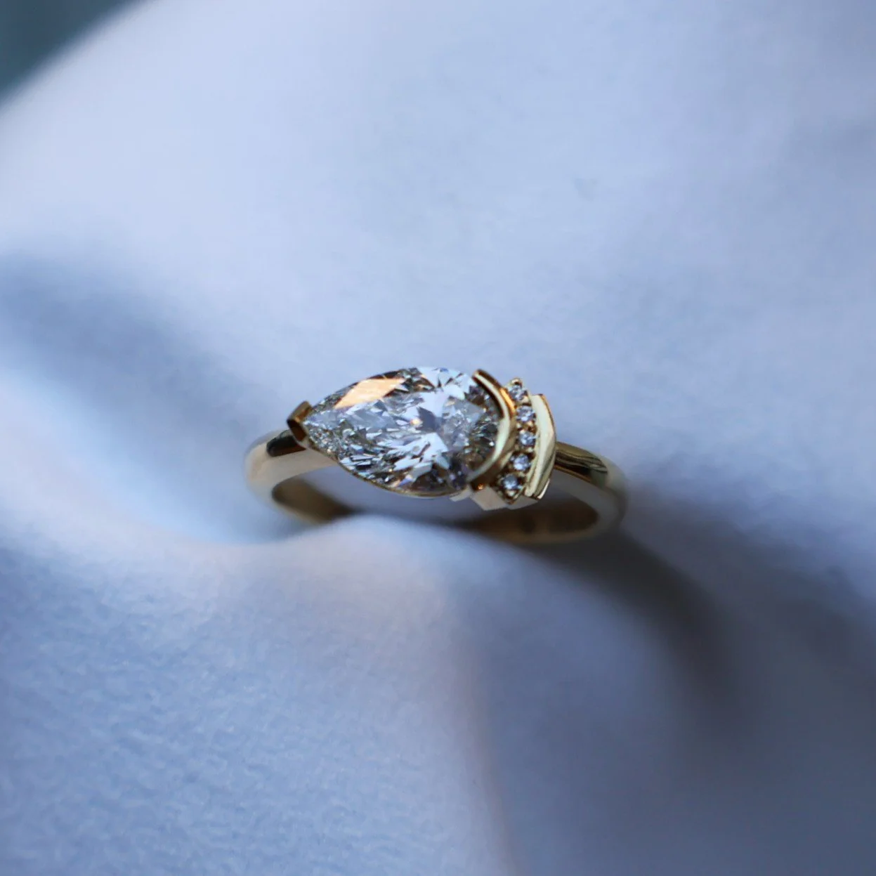 Modern art deco ring made in 18ct yellow gold featuring a 1.26ct pear lab diamond