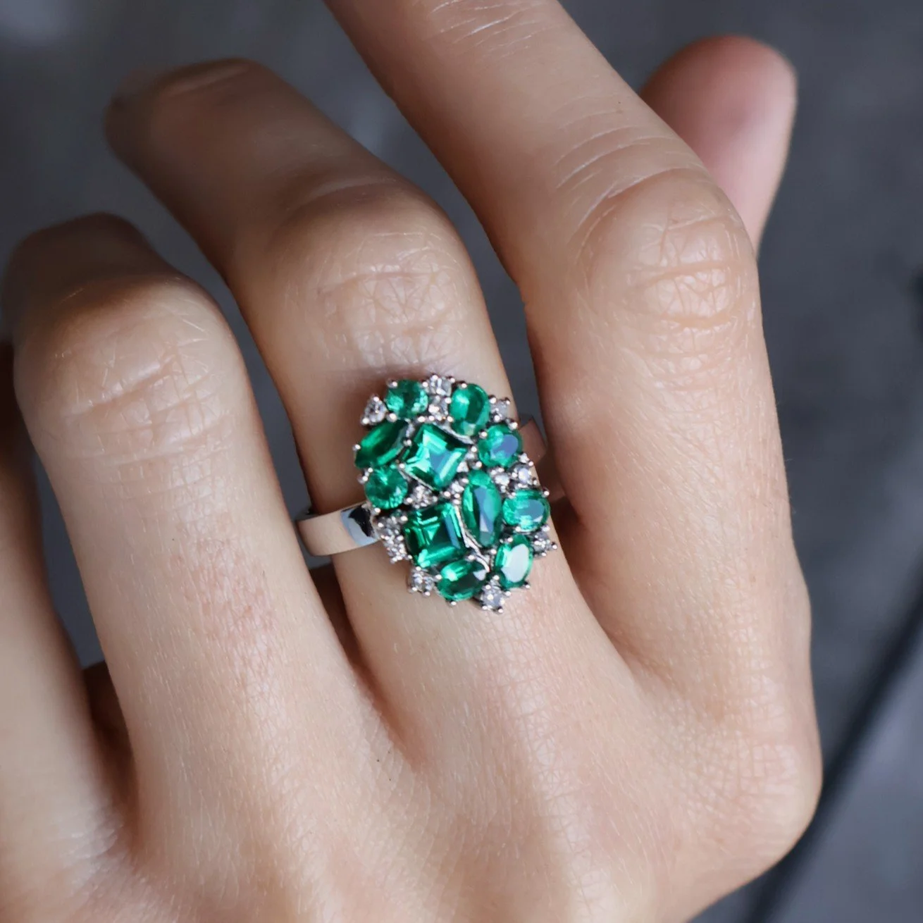 Emeralds and diamonds set into a platinum ring after remodelling