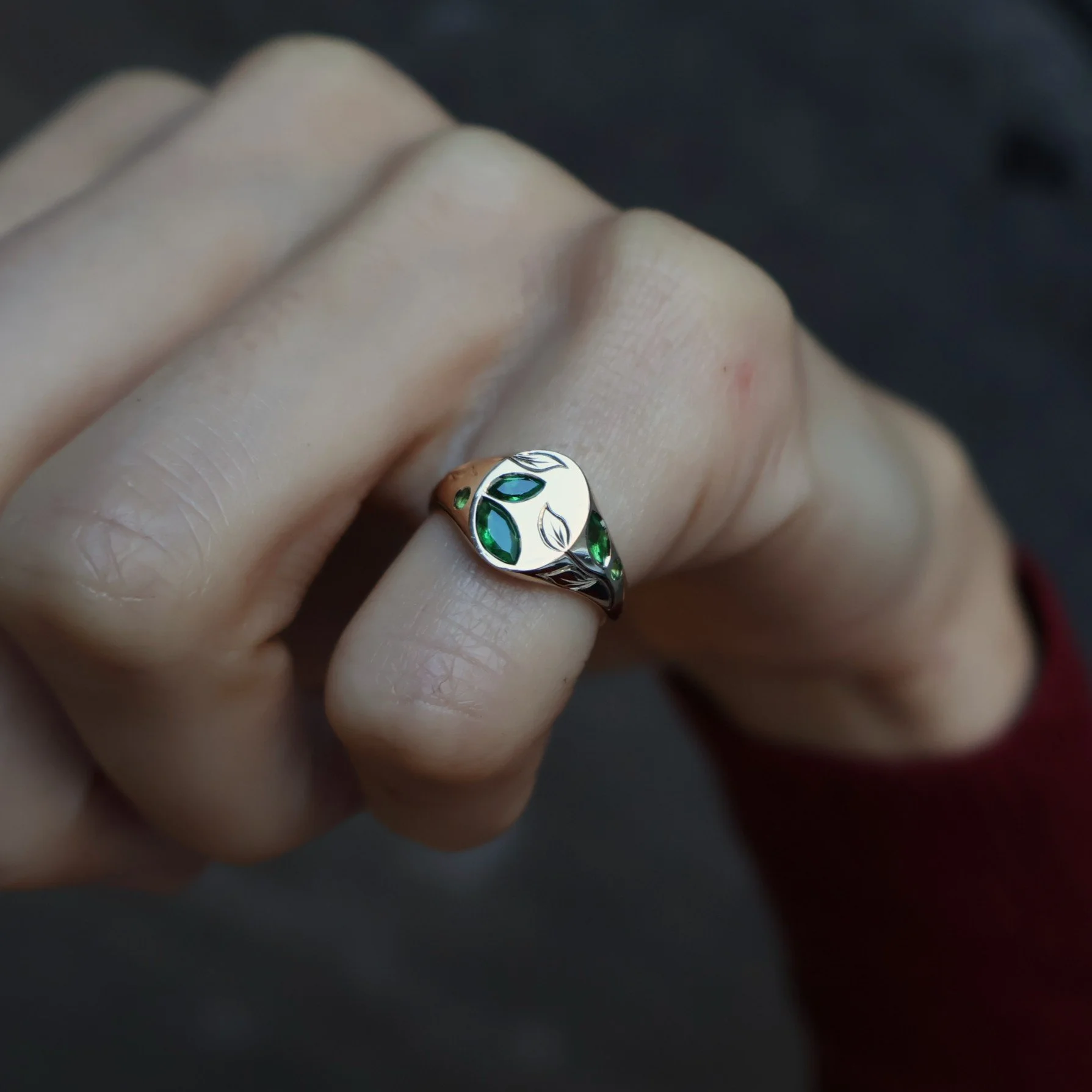 engraved leaf signet ring set with green gemstones