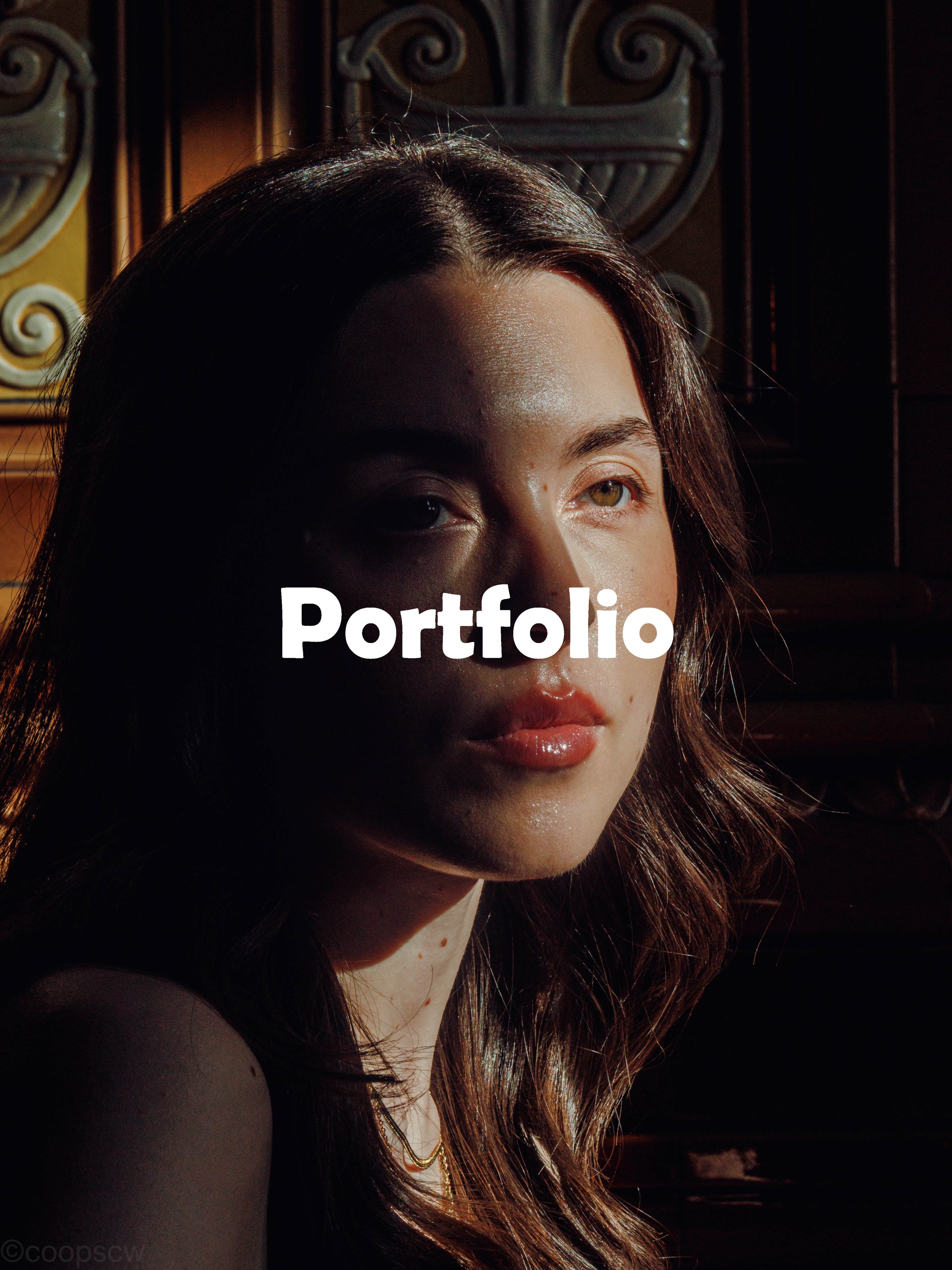 Documentary-style portrait of a woman lit by strong directional light, used as a portfolio image by Manchester photographer Lee Cooper.