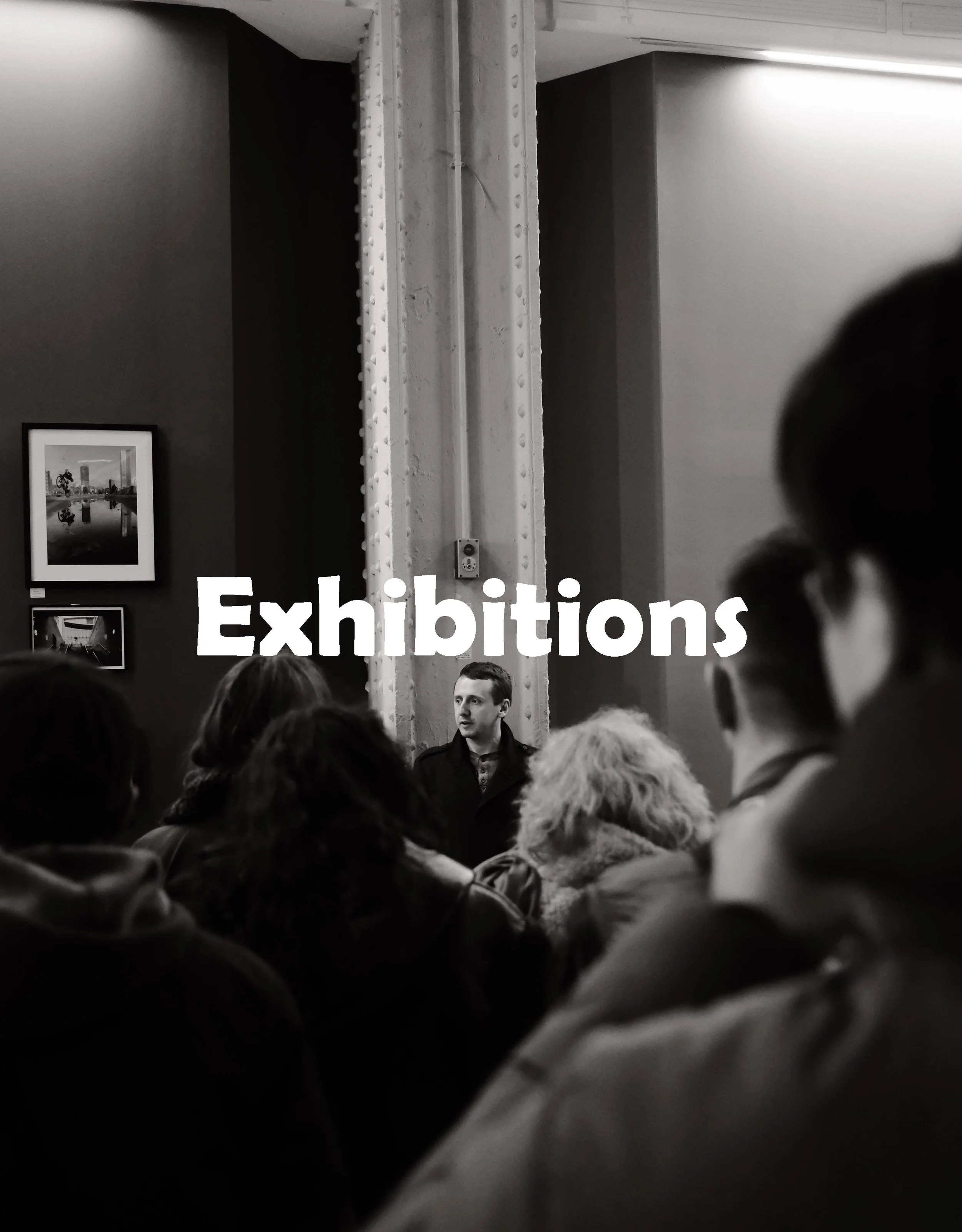 This image Manchester Photographer Lee Cooper in a moment of public engagement during a photography exhibition, reflecting a practice rooted in dialogue, community, and shared space. The work forms part of an ongoing documentary and social practice a