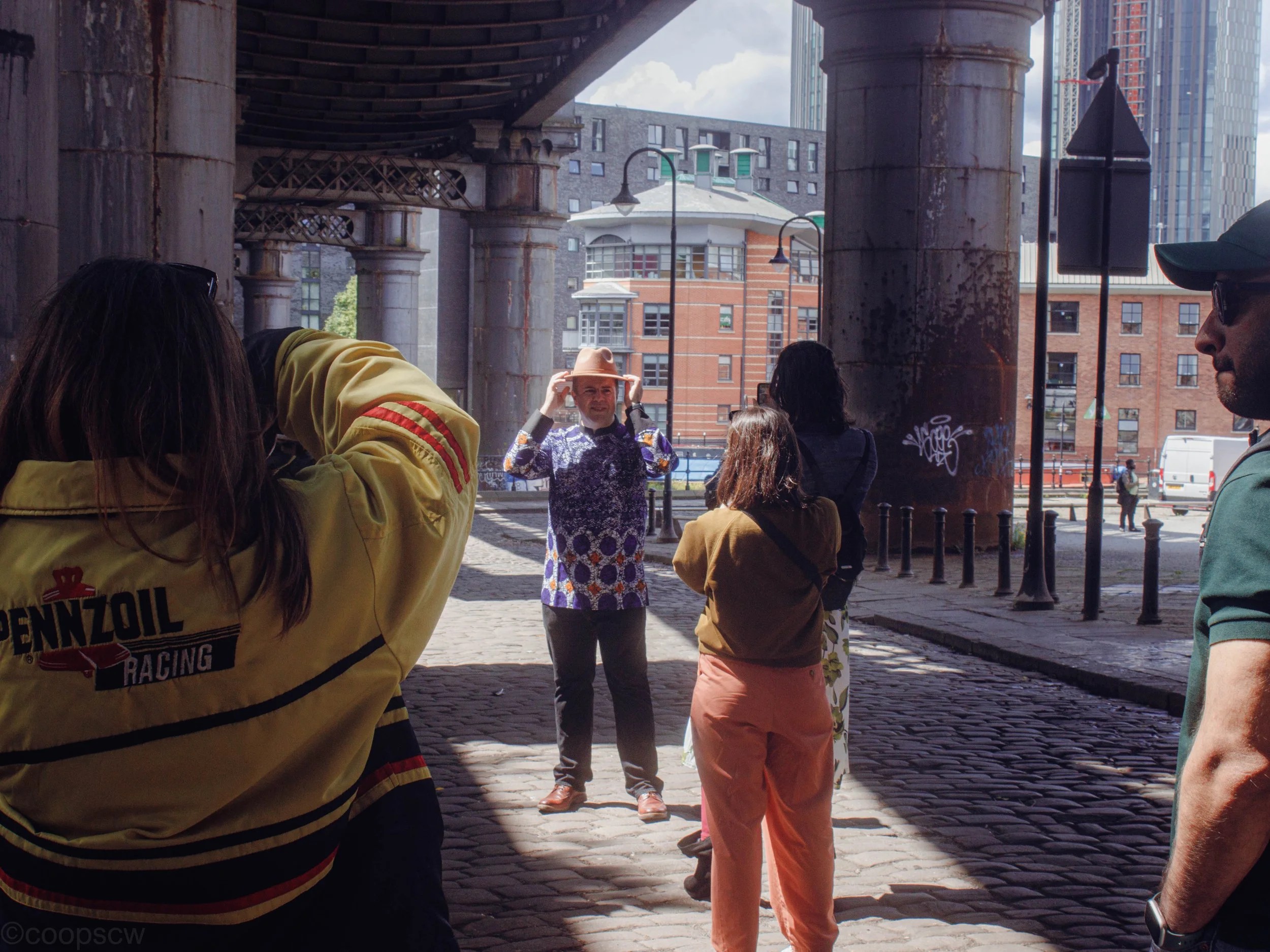 Photographers gathered beneath railway arches during a Manchester Photography Collective photo walk.