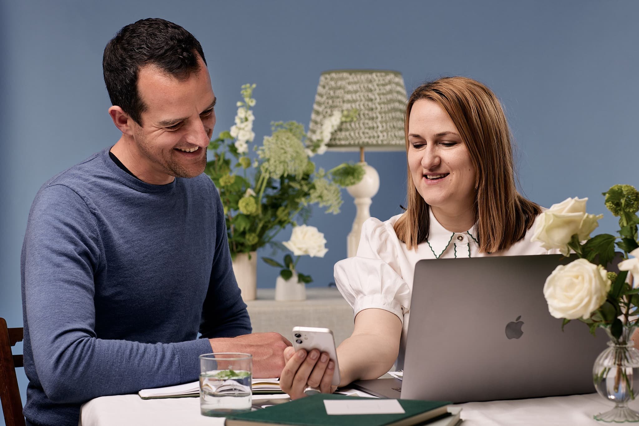 Smiling woman & man at website design studio presenting a beginner's guide to getting started with website SEO by Wildings