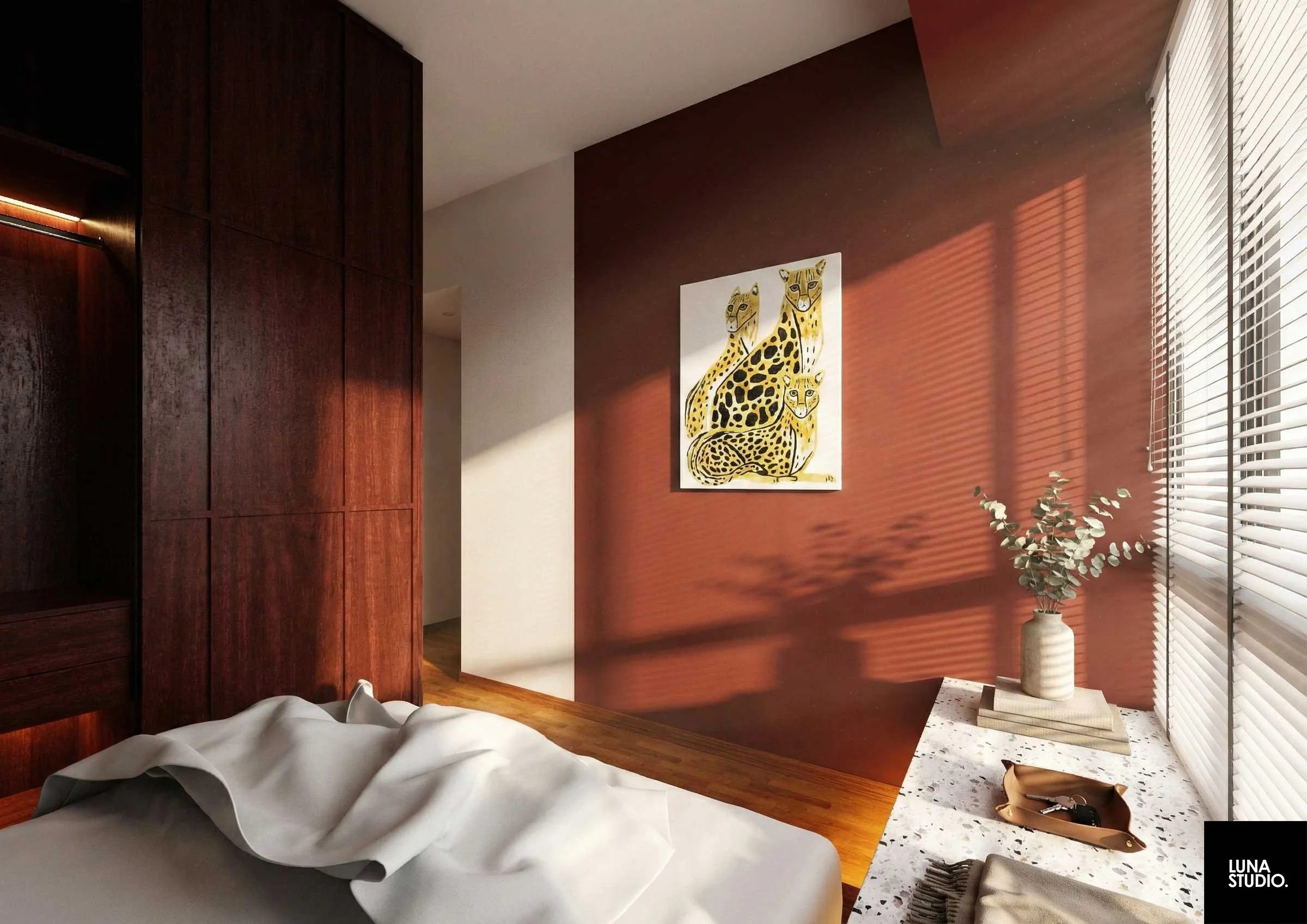 A bedroom corner with a bed partially visible, dark wood wardrobe on the left, a reddish-brown accent wall with a painting of three cheetahs, and a window with white blinds casting shadows. A beige vase with eucalyptus branches and a tray with keys are on a speckled nightstand.