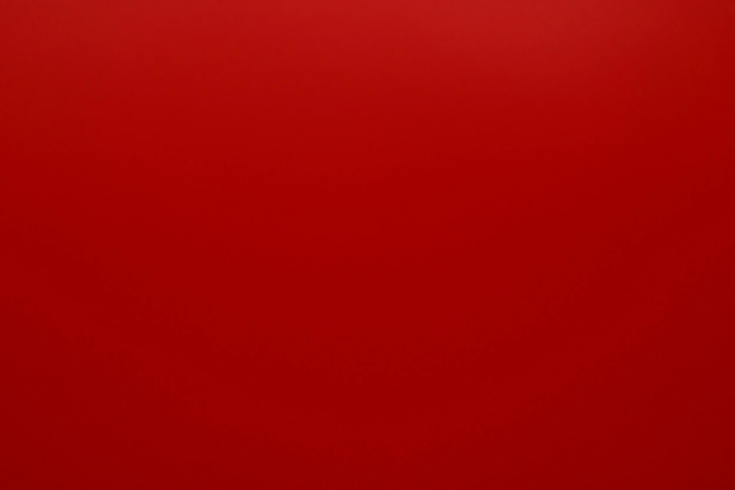 Solid red background with no objects or details.