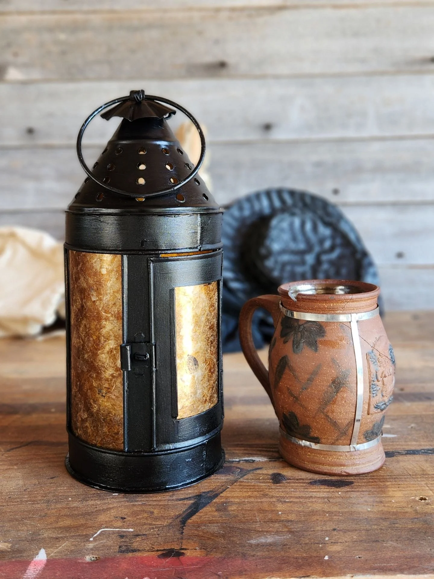 A 17th century style round lantern black paint and amber door panes.