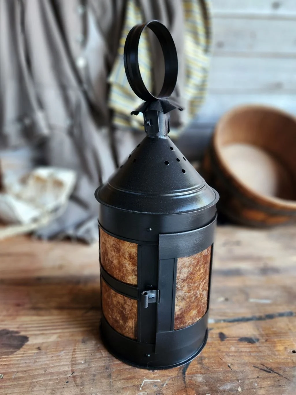 Kate's Round ship lantern, a handmade tin lantern with amber window panes.