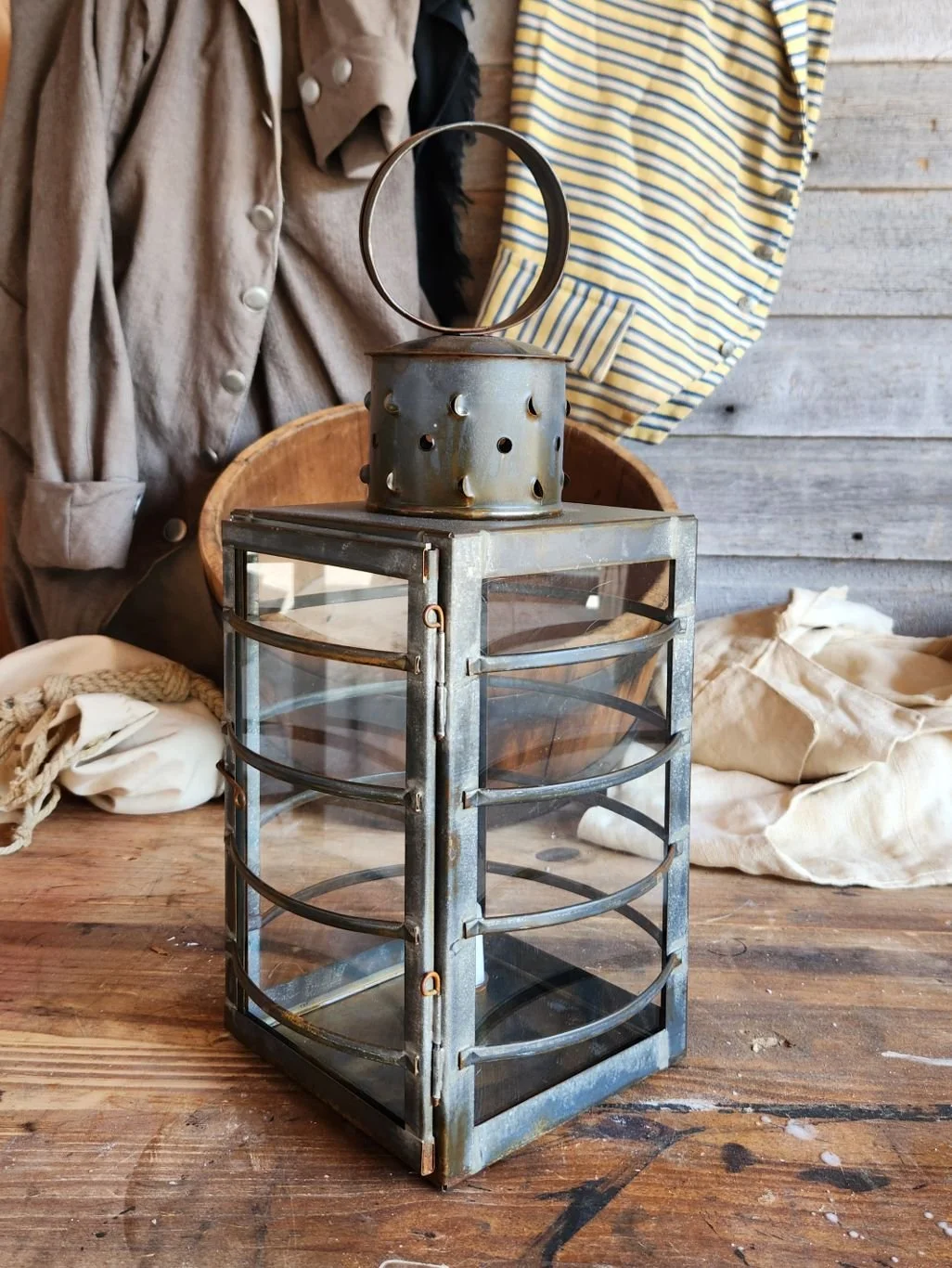 Square tin square watch lantern with antique finish.