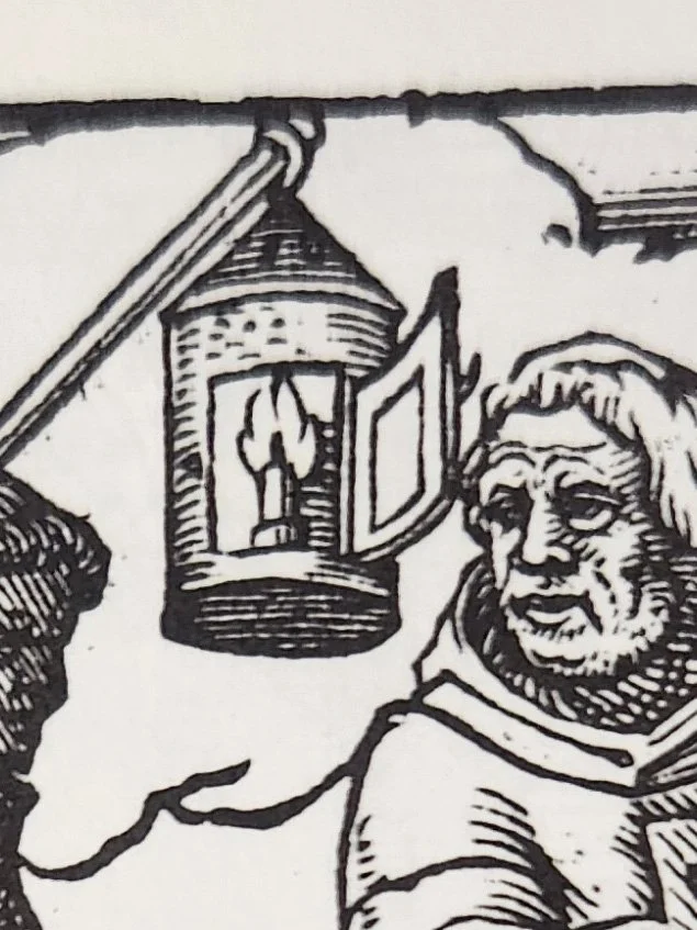 A detail of a 16th century woodcut showing a hanging round tin lantern with the door open.
