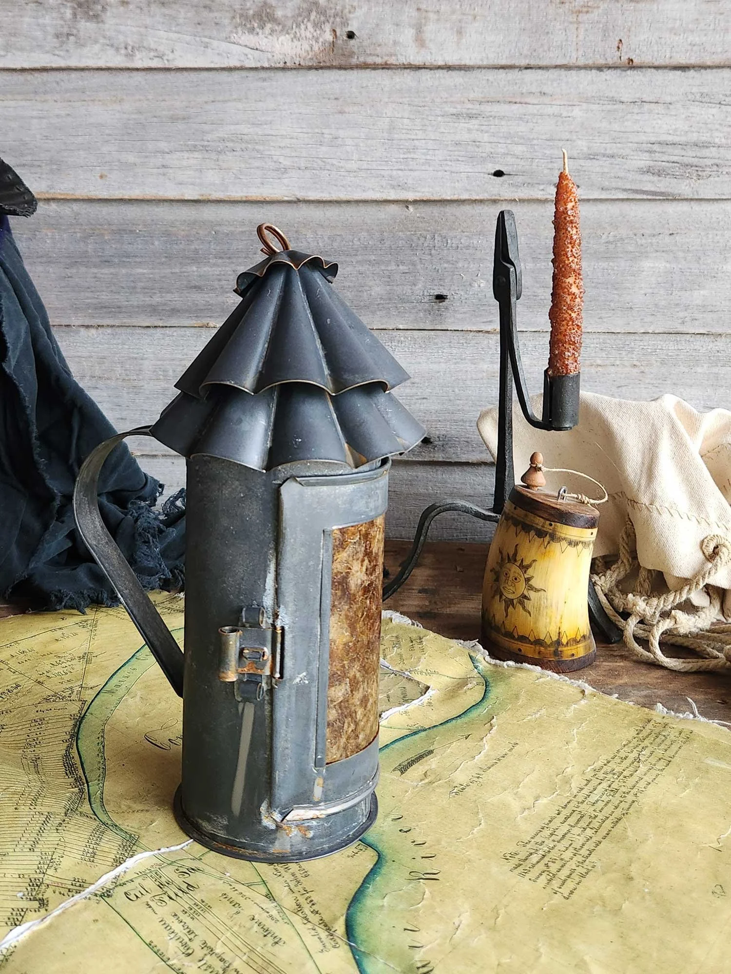 Small hand lantern with double scalloped top cones.