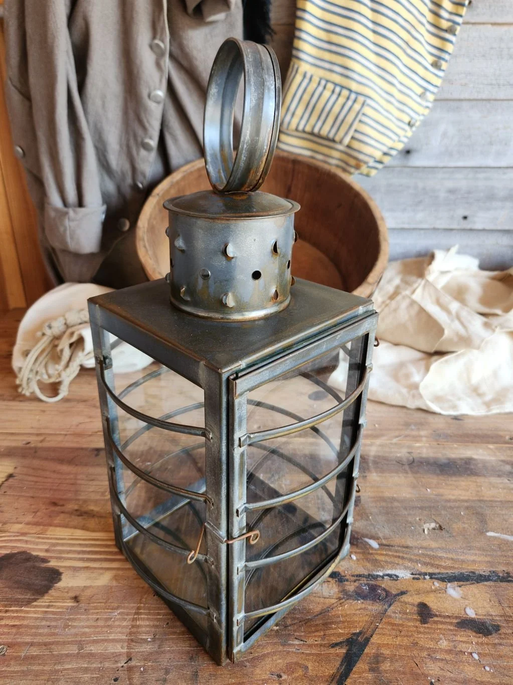 Square tin watch lantern with clear glass.